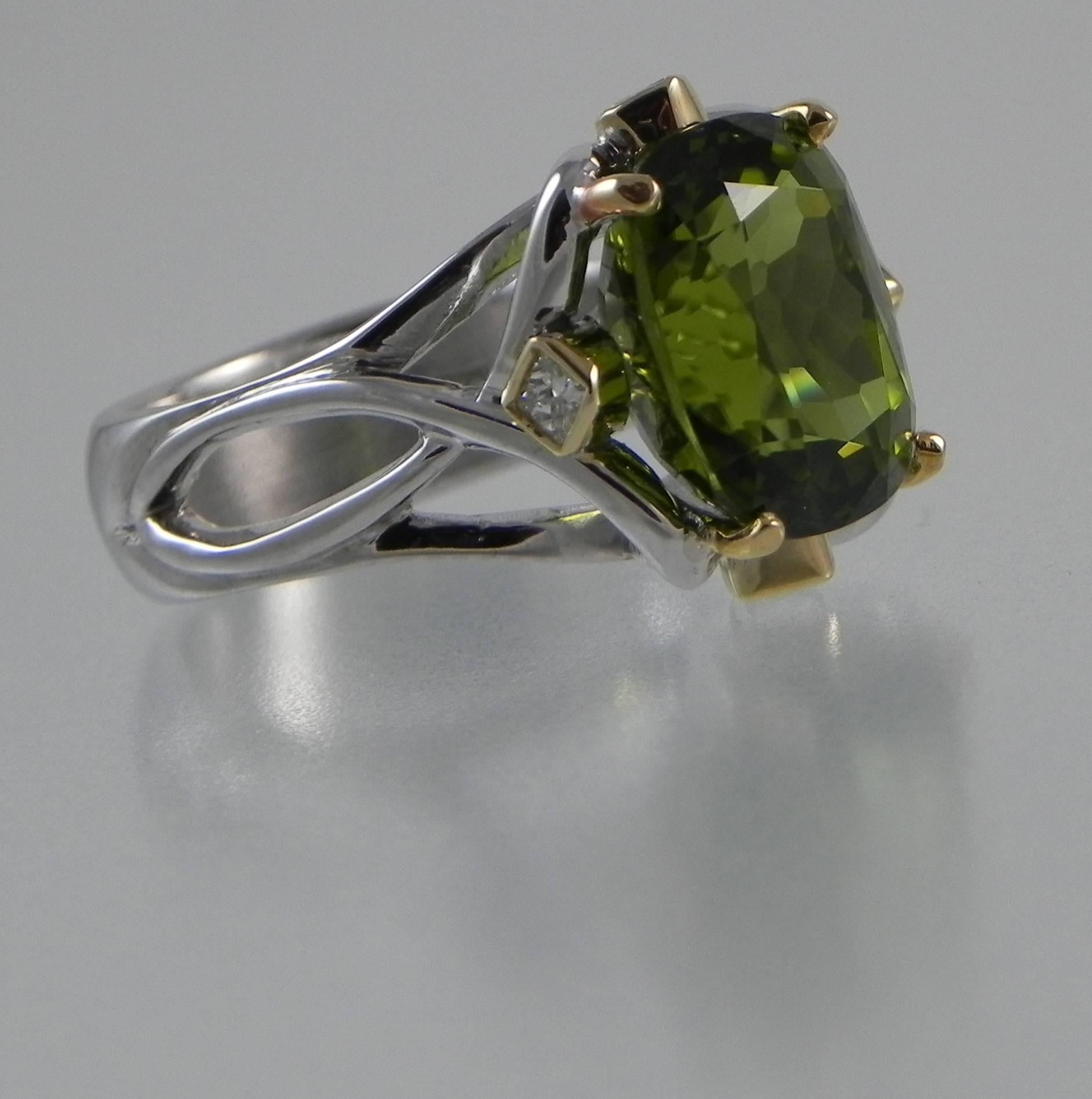 One-of-a-kind and handmade ring by Colorado’s Premier Jewelry Design Studio and Master Craftsman – Steven M. Parks.  A volcano did indeed grant us with the gift of this fine gem quality Burmese Peridot. Our master craftsman then created a work of