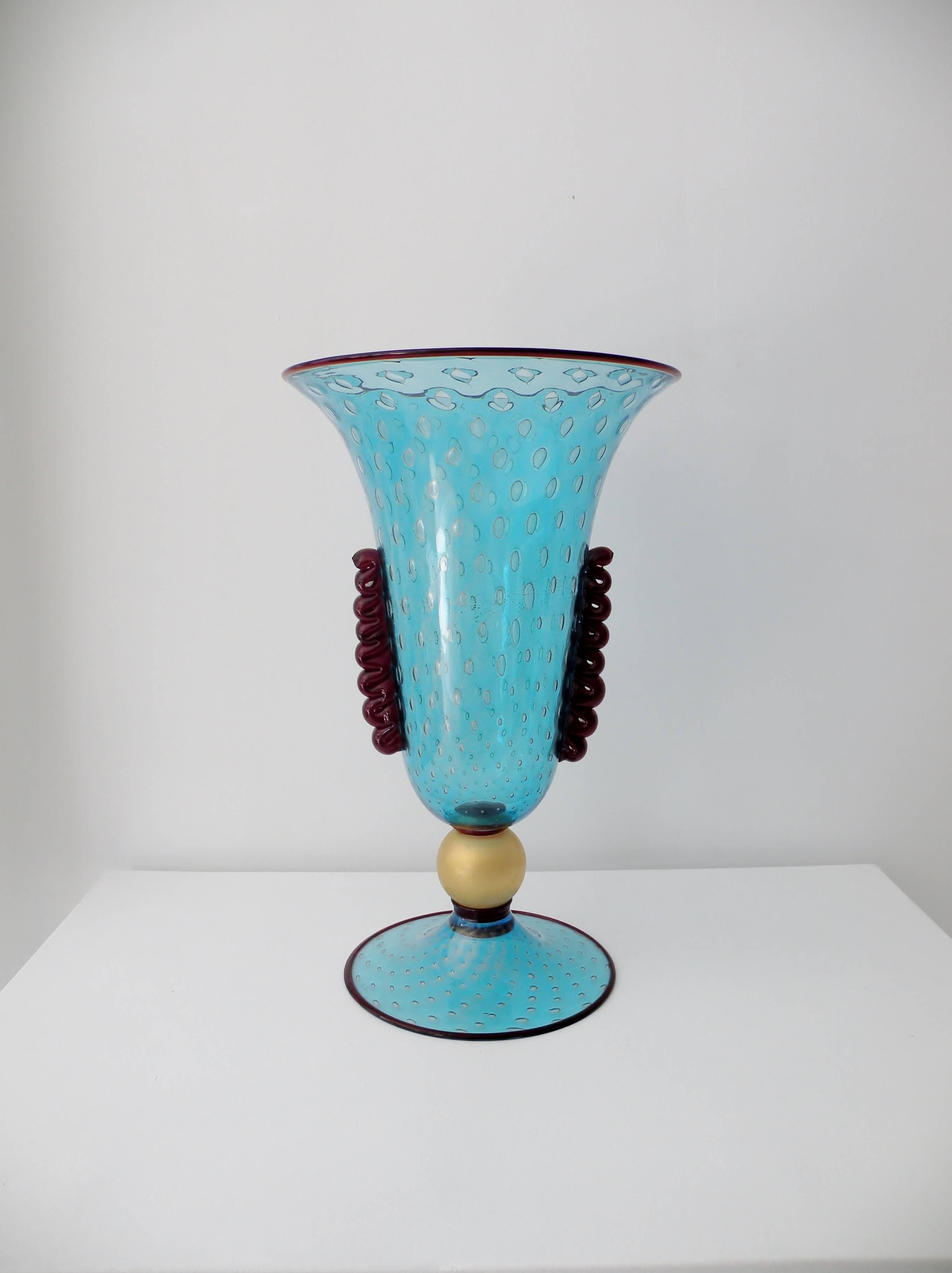 Outstanding monumental fine thin walled trumpet form vase with a teal blue body, Aventurina flecks and Bullicante controlled bubbles on a gold foil ball stem with ruby glass detailing to rims and sides. Approximate 17.75