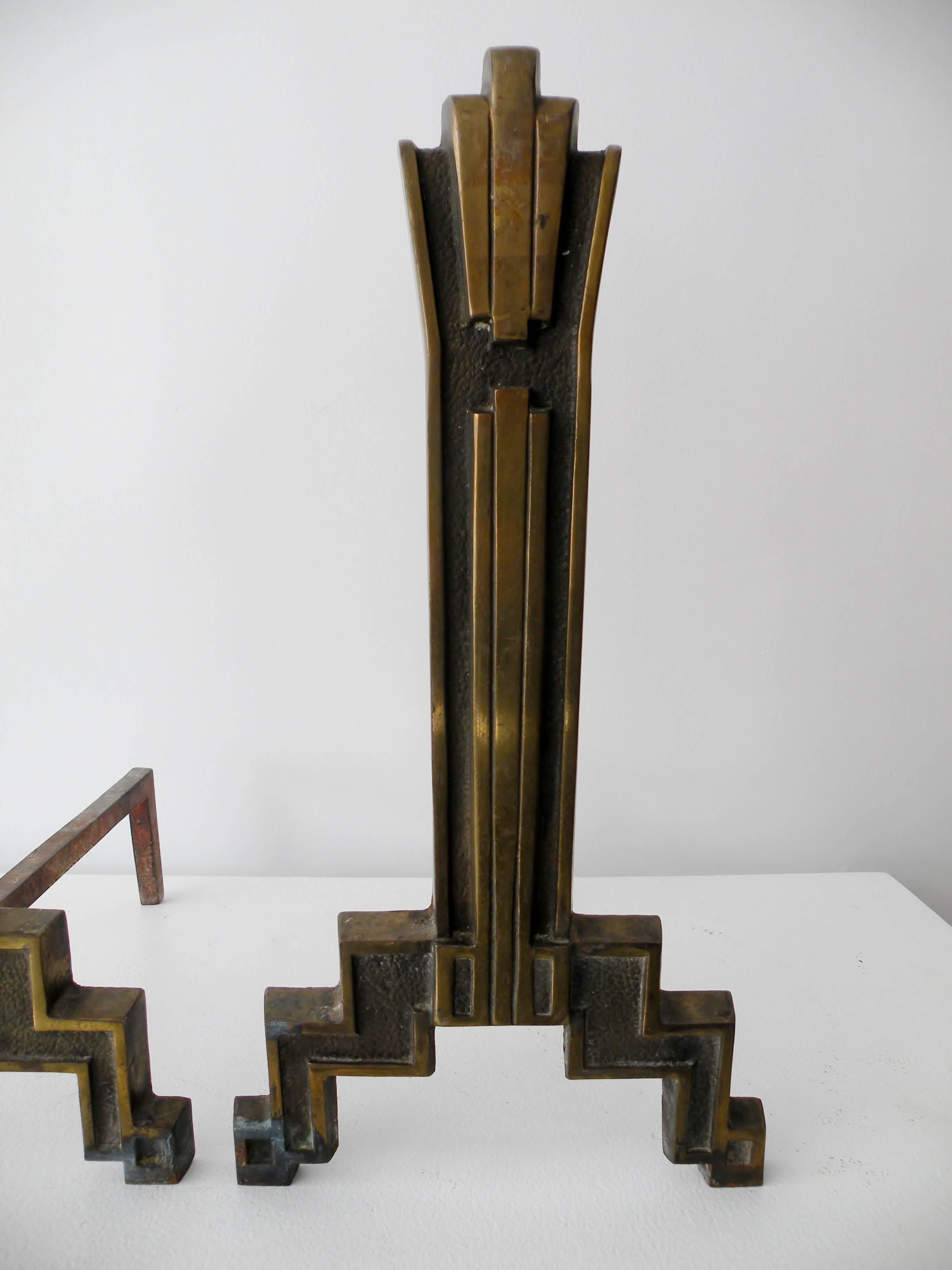 Pair of 1920s era cast iron geometric skyscraper styled Art Deco fireplace andirons or firedogs. Total height 18.5
