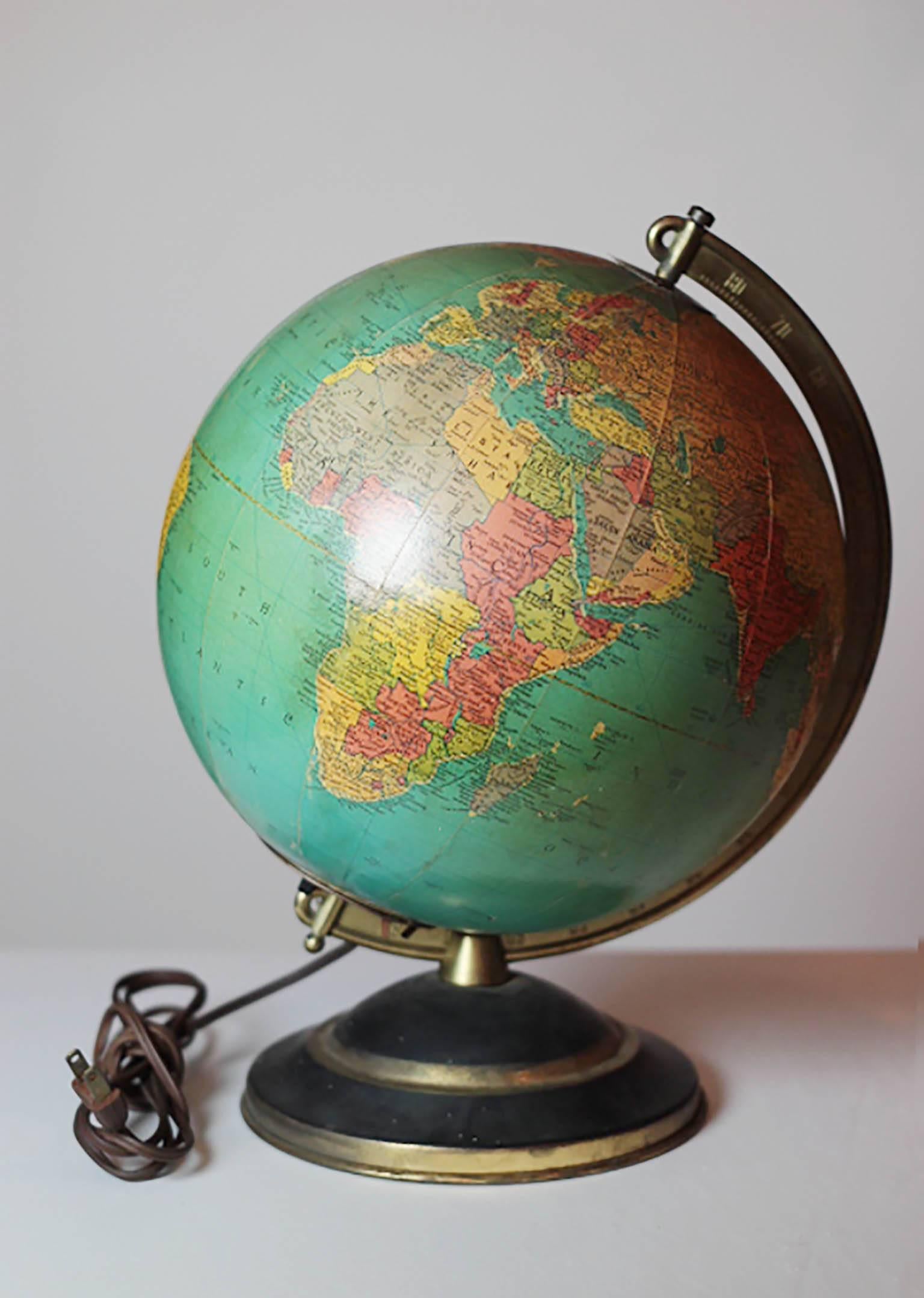 Illuminated glass globe with solid brass bracket and brass plated base. The globe plugs in and has an on/off switch at the base of the globe.
The cord is in excellent condition.