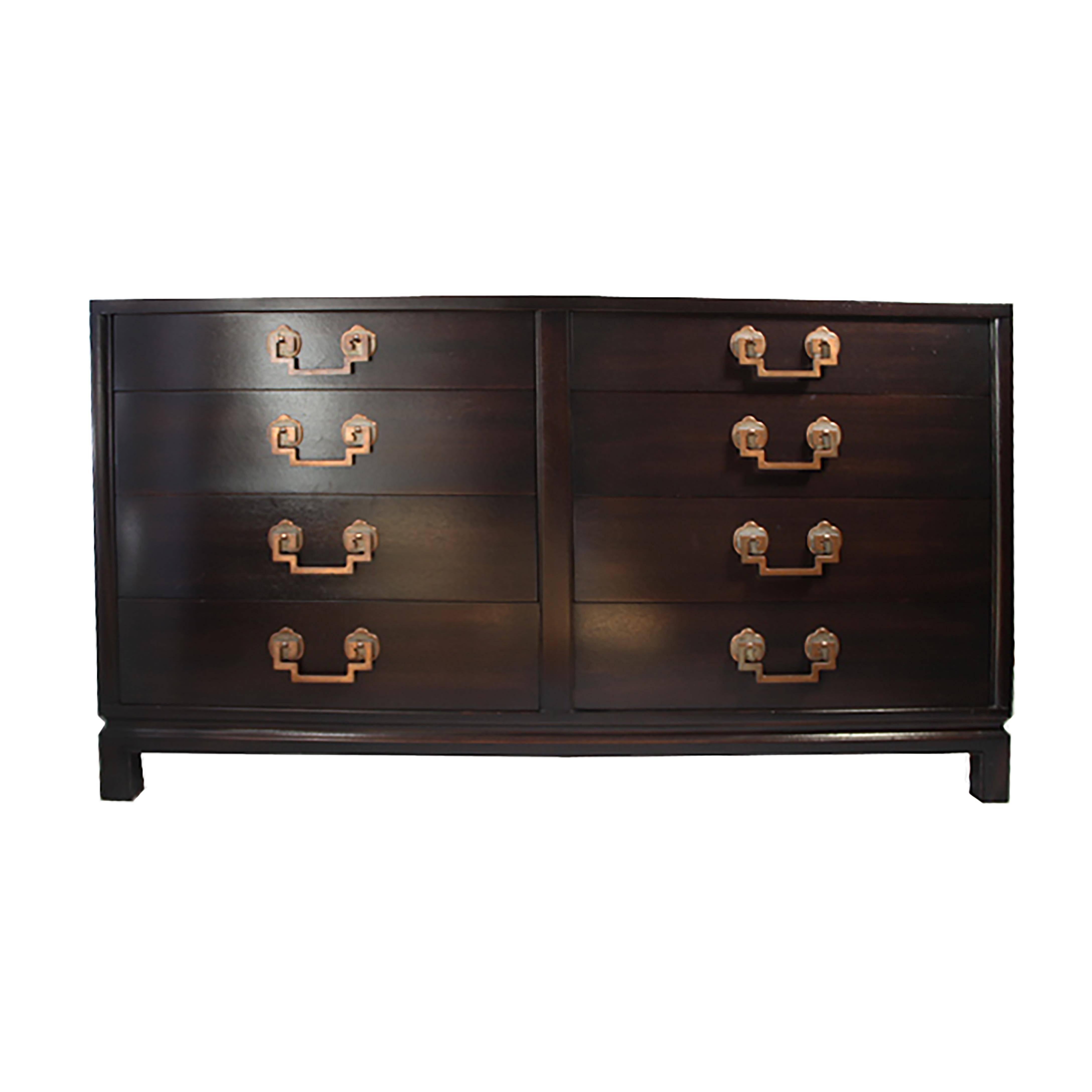 Eight-drawer Asian style dresser manufactured by Landstrom Furniture of Rockford, Illinois. Ribbon mahogany finish, chinoiserie styling with aged copper and nickel drop Greek key pulls.