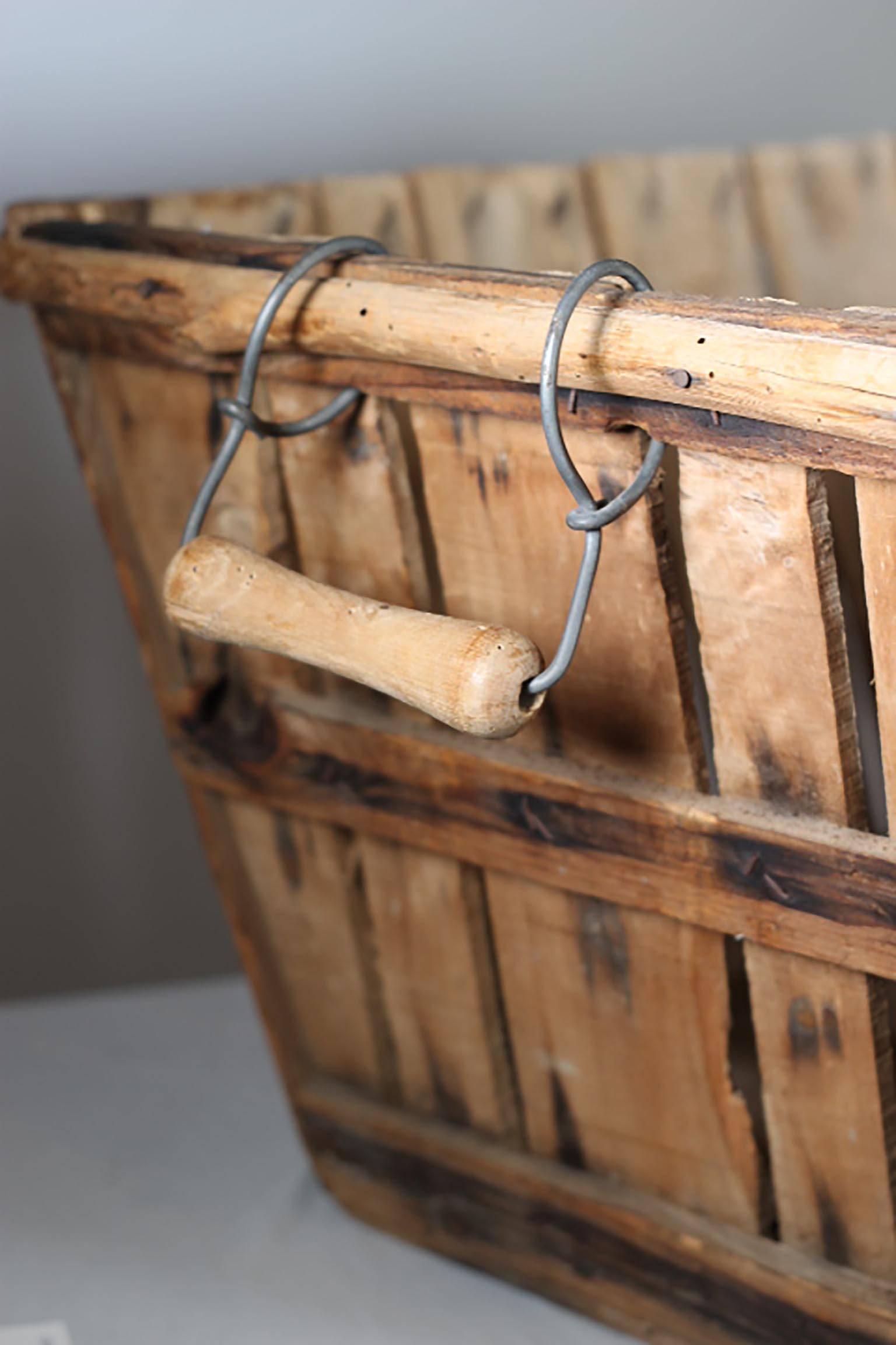 Antique apple orchard basket with metal and wooden handles, circa 1930s-1940s.