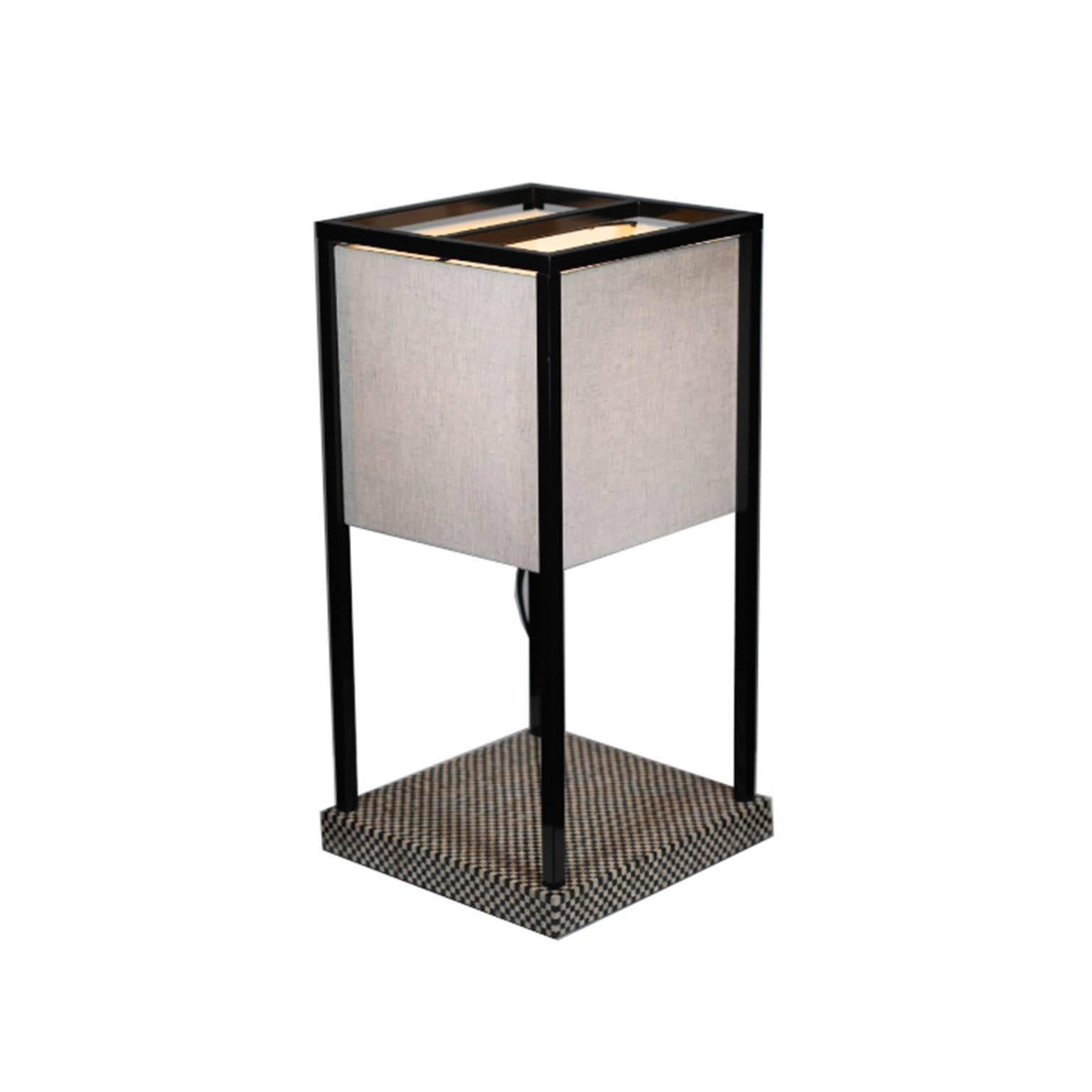 Table lamp with lantern grip. Checkerboard black and beighe wooden base and satin black nickel frame structure. Lampshade available with light caramel parchment fabric. Made in Italy.

Armani has discontinued this particular lamp. 

 
