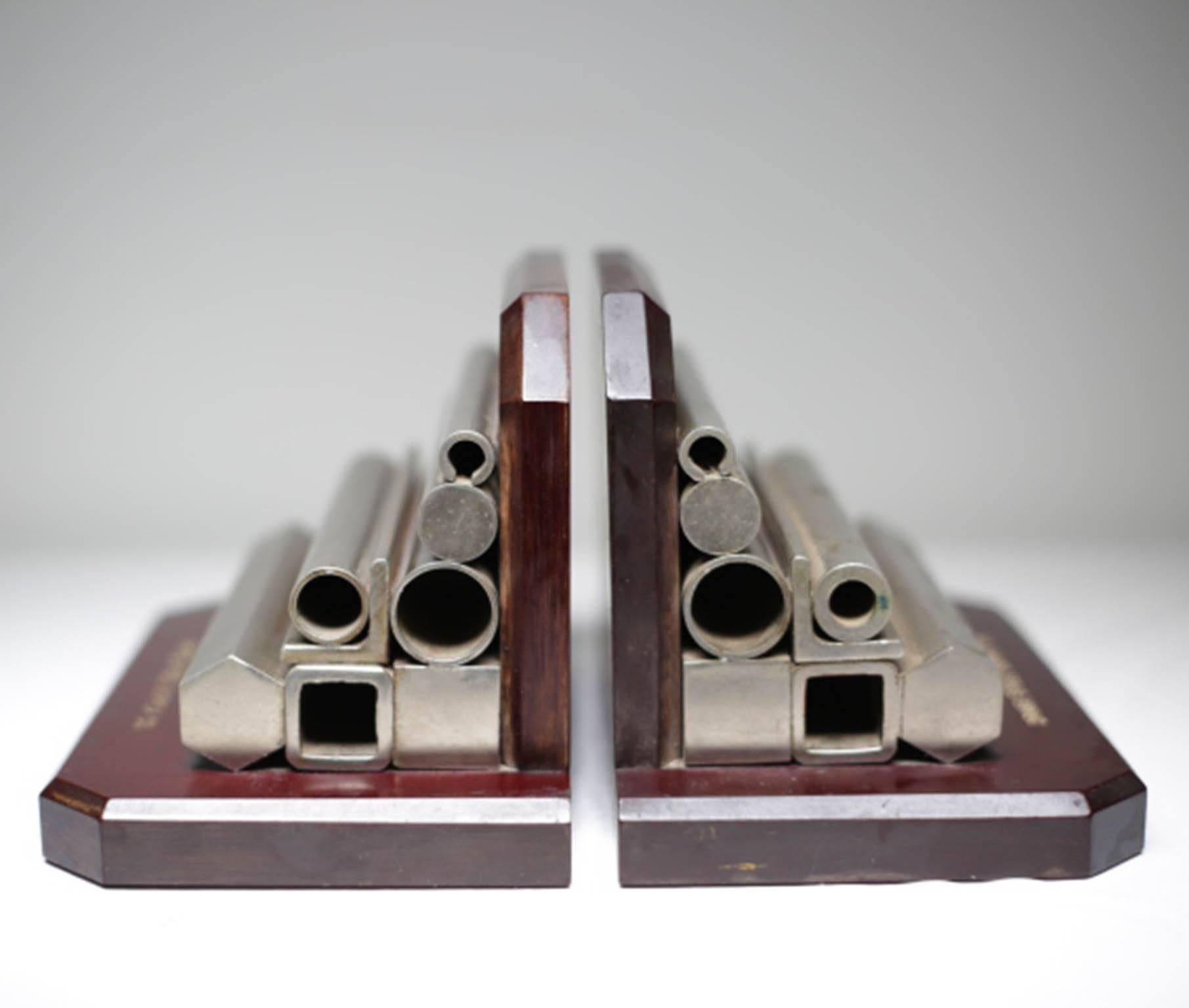 Substantial wood and cold-rolled steel bookends from the Drake Steel supply company that supplied the steel for the golden gate bridge. Look great pushed together as a sculptural piece.