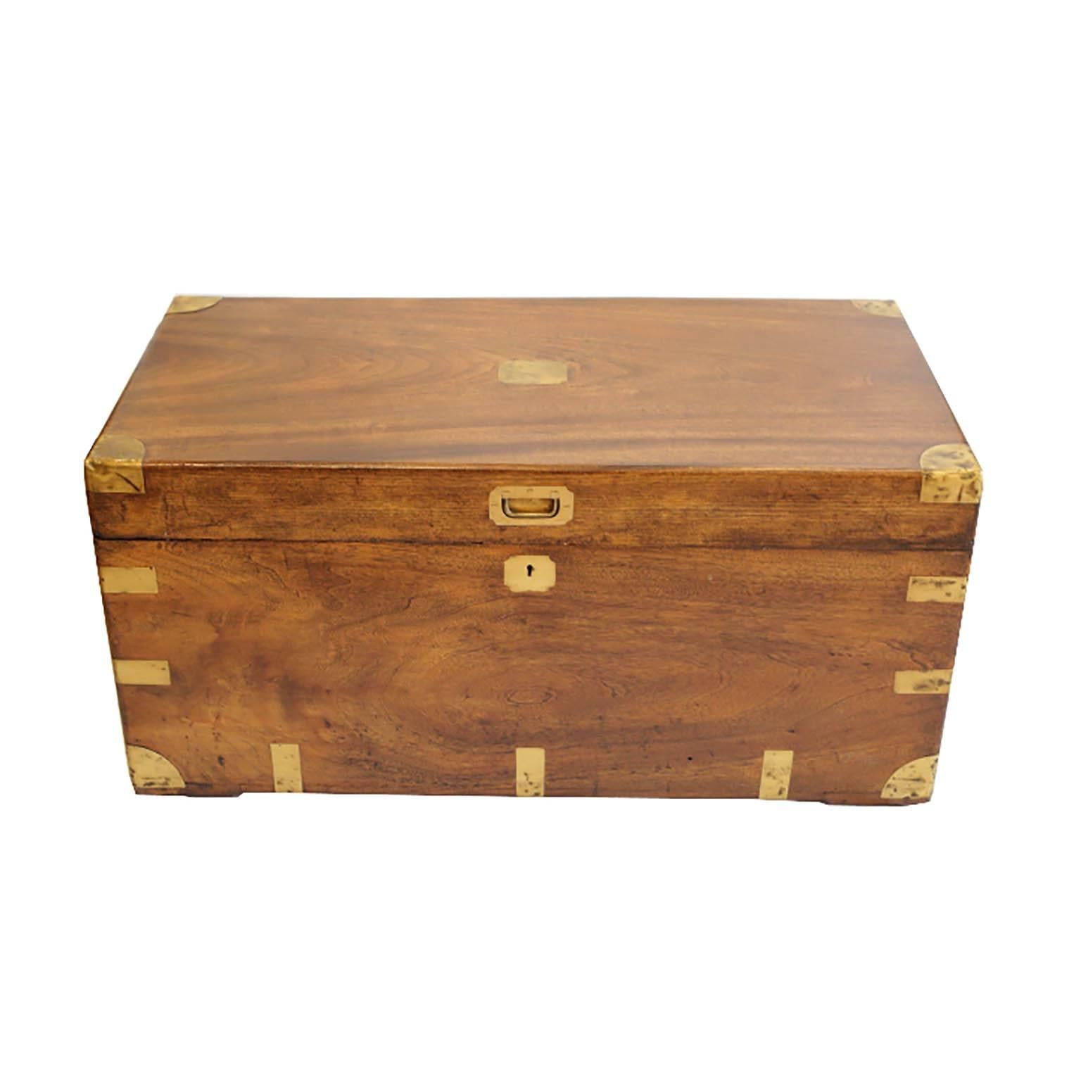 A mid-19th century military camphor wood traveling trunk.

The camphor wood trunk consists of brass trim, a plain brass plate to the top, recessed handle, and solid brass carrying handles

Missing one brass corner in the back denoted in pictures.