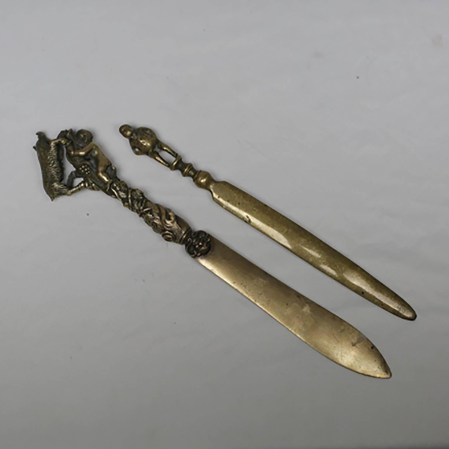 Two bronze letter openers may be sold separately. 

Large bronze letter opener depicting a boy with a goat. 
Measures: 9.75