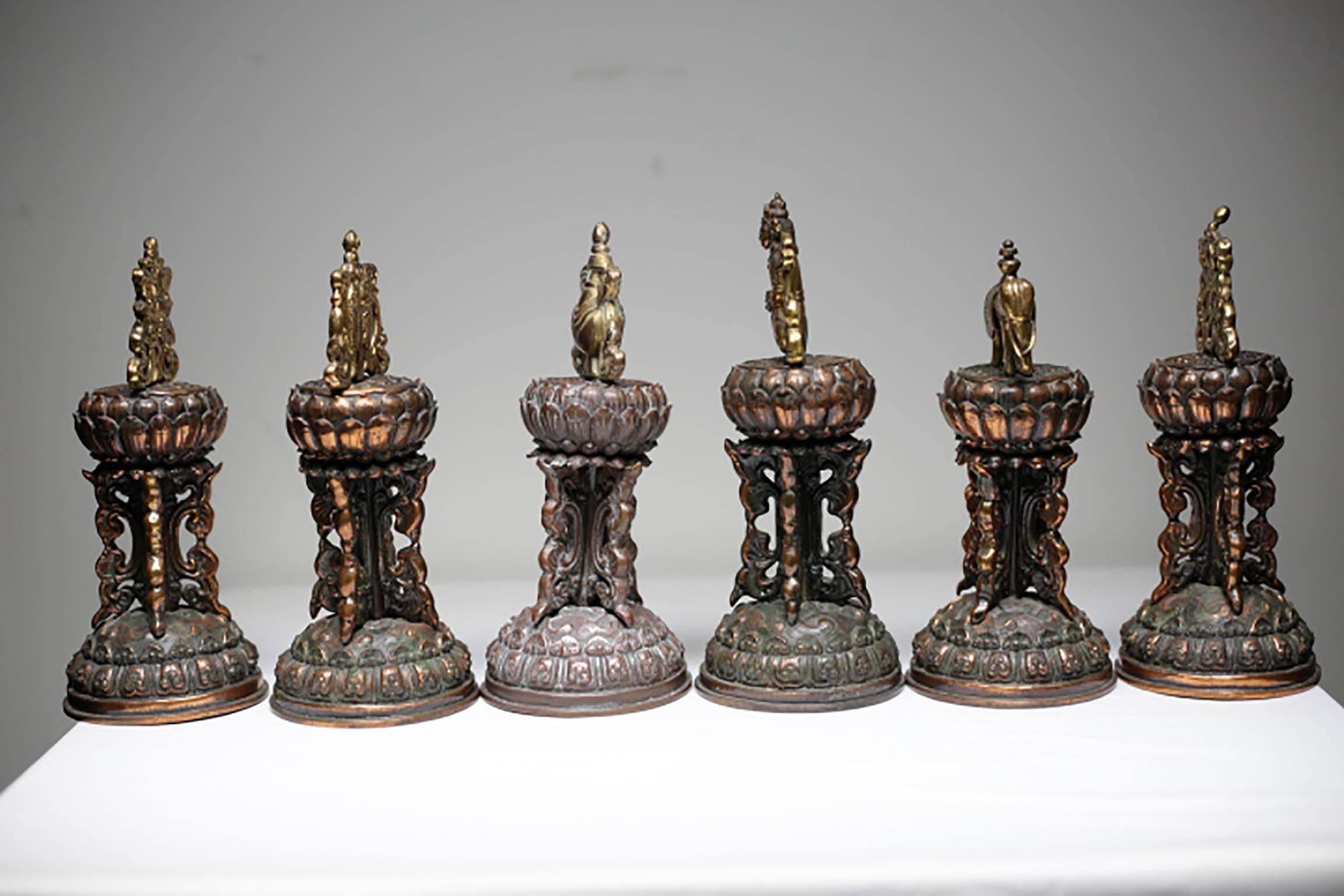 Collection of six bronze plated Balinese or Tibetan temple bells each depicting a different motive on top.
The bells are all missing from the inside.