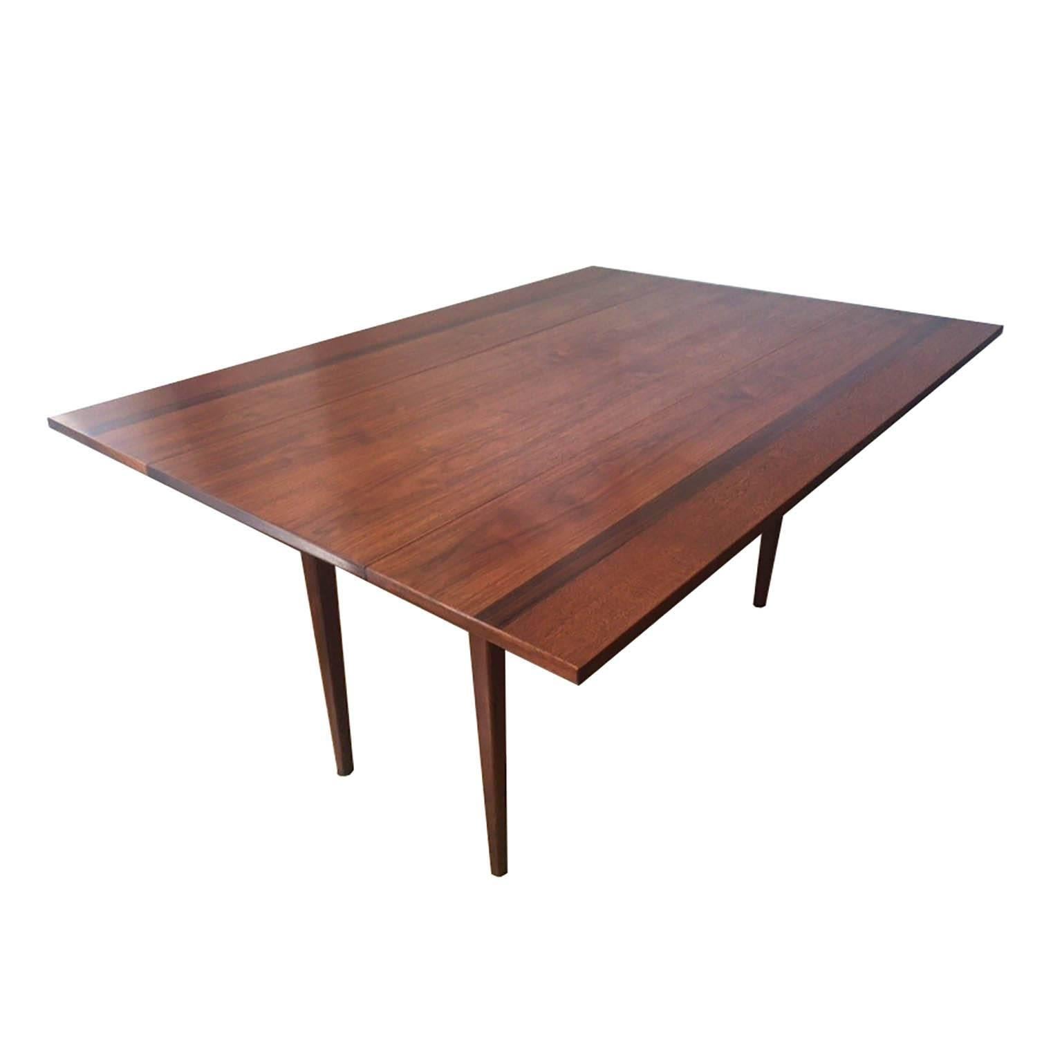 ABOUT
This is an original Hibretin Drop Leaf Console/Dining Table. The piece is constructed out of Walnut with an outer strip of Mahogany on each side and an inner strip of Rosewood on each side. The piece has retained its original finish and is in