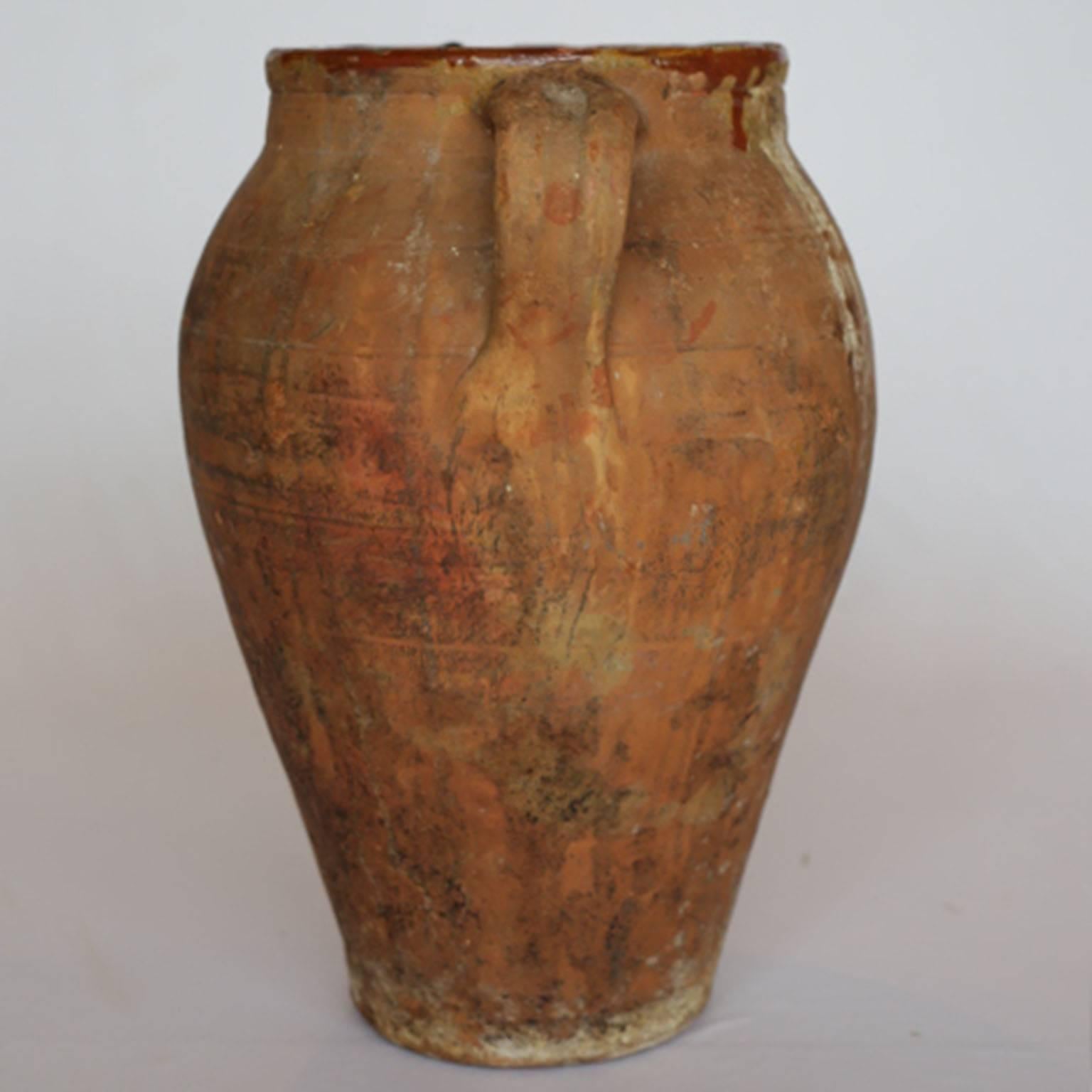 Large wide mouth semi-glazed terra cotta Italian olive jar. Glazing on the top rim.
Chips on the rim. Large cracks on both sides that appear to have been repaired sometime in its lifetime. Structurally sound though. Unsure if it can hold water.