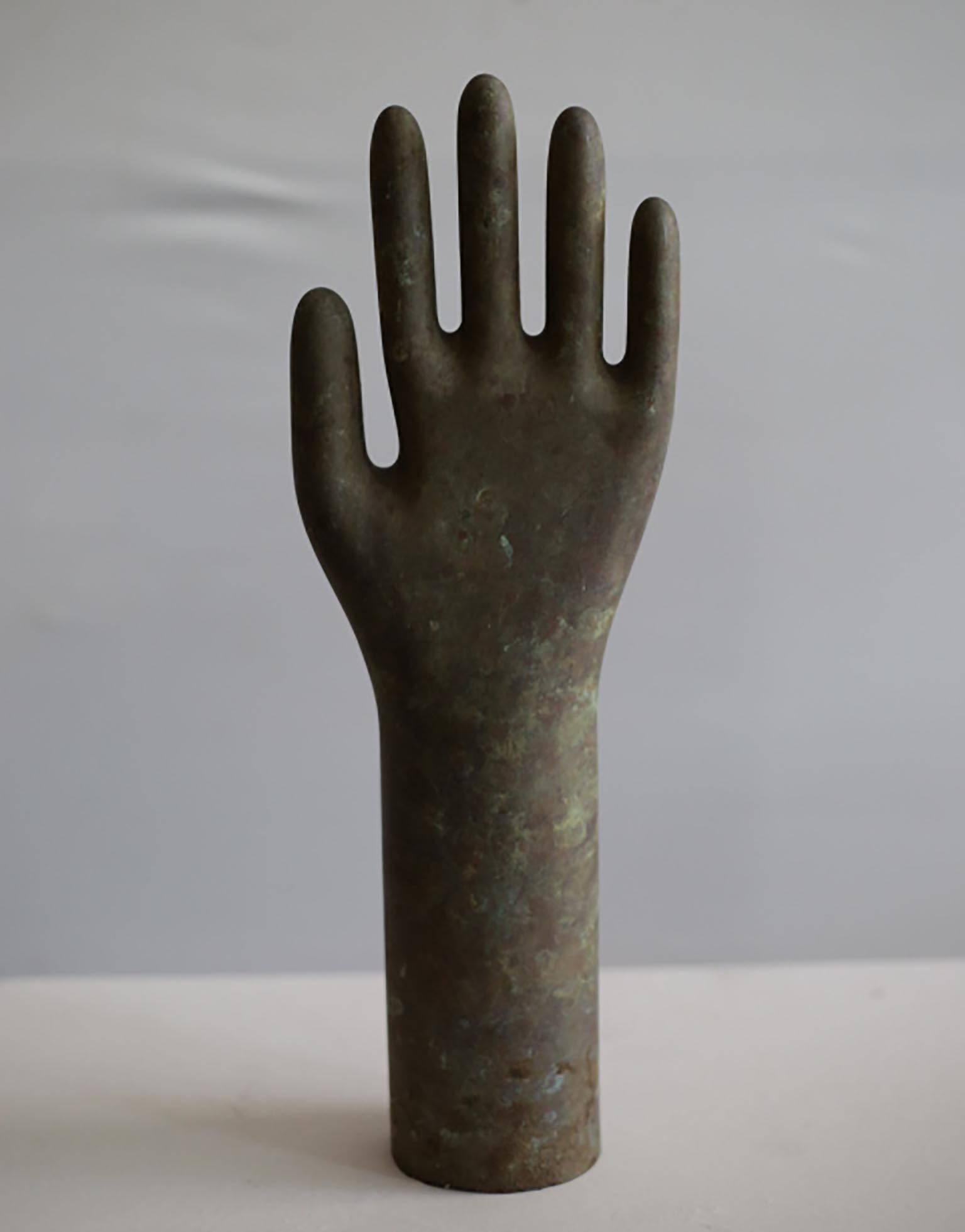 Aluminium glove mold, circa 1940-1950s, stands up on it's own. Great to accessorize a shelf or coffee table. Mount it on a metal stand or hang it on a wall perpendicularly. Could also be used a towel or coat holder.