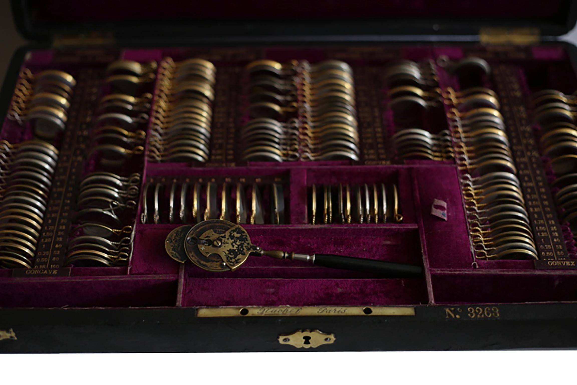 ABOUT

An original Victorian optometrist eye testing kit by Nachet & Fils, Paris #3263. The kit is a leather case lined in purple velvet filled with glass optical lens wrapped in brass. Each lens fits into a numbered and named slot in the case. A