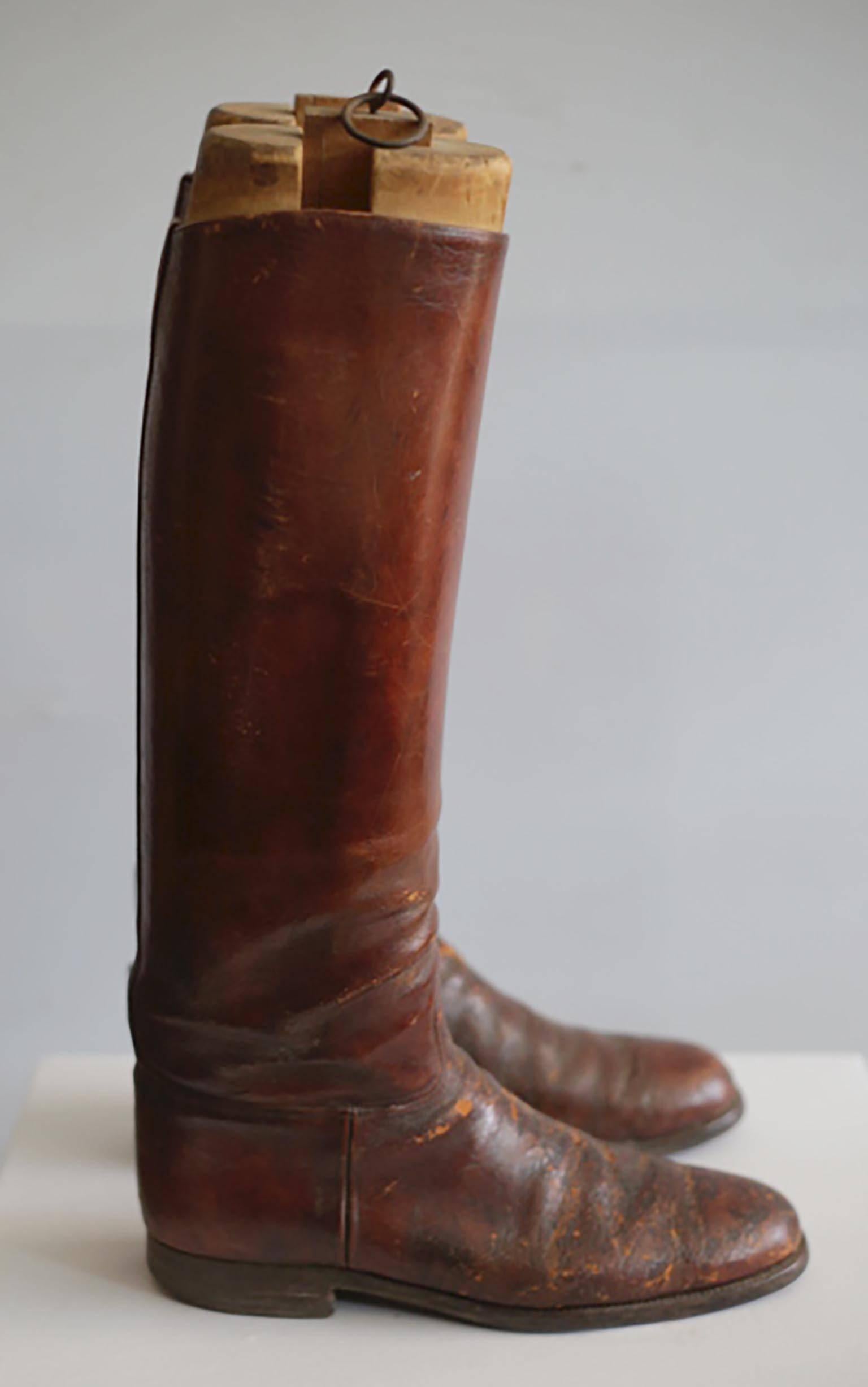 ABOUT

This is a decorative pair of handmade vintage men's equestrian riding boots. They come with the original wooden boot forms. The wooden boot trees have some wear, as does the boot's leather from decades of use.

CREATOR Unknown, USA. 
DATE OF