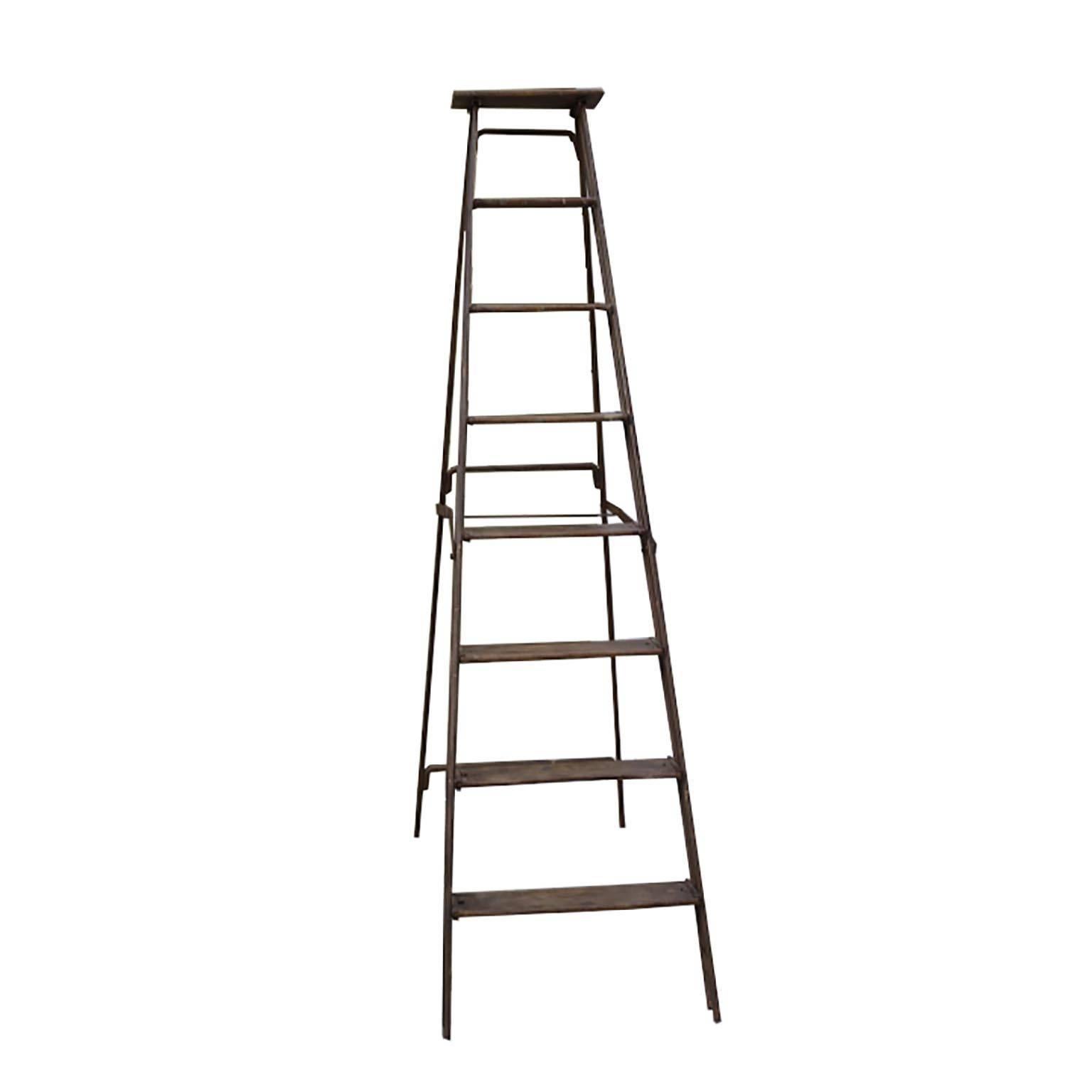 Steel frame ladder with wooden rungs, circa 1930s. Folds in for easy storage. The two bottom rungs are slightly loose.
The ladder itself can be used to climb. Does have a slight wobble.