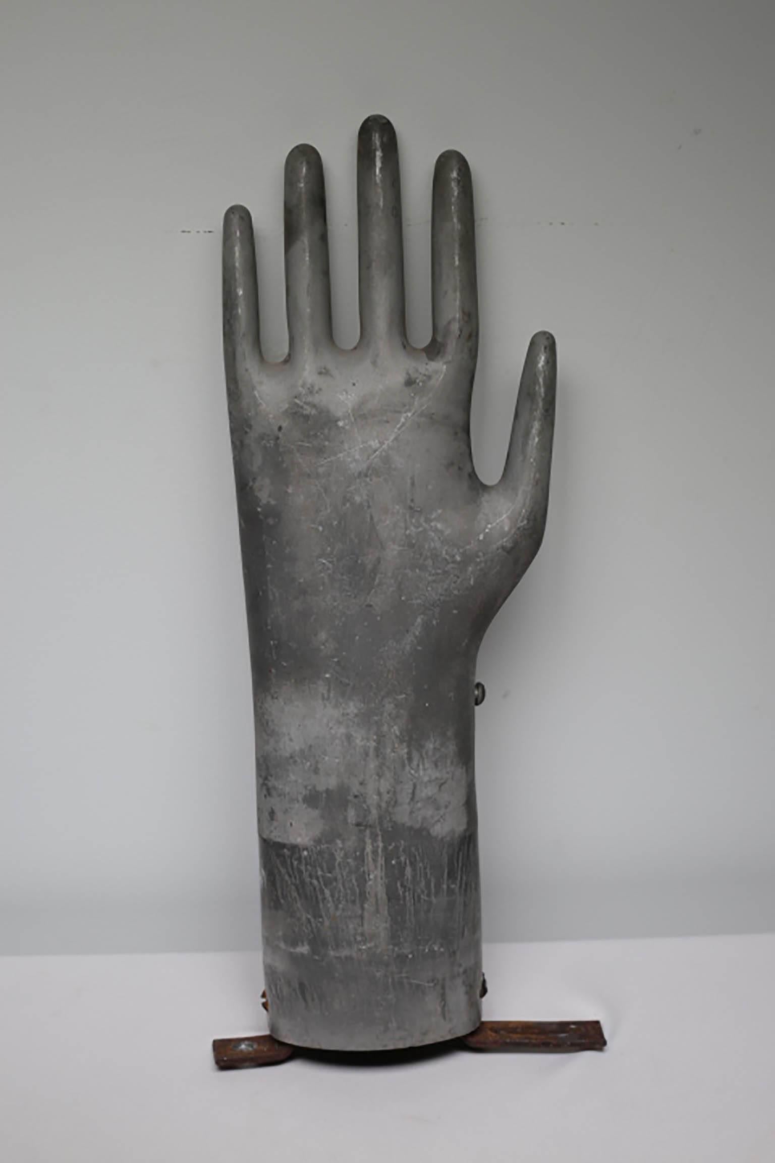 Mountable aluminum glove mold with steel bracket circa 1950s-1960s. Mount on the wall to use as a coat hook, towel hook or just by itself.