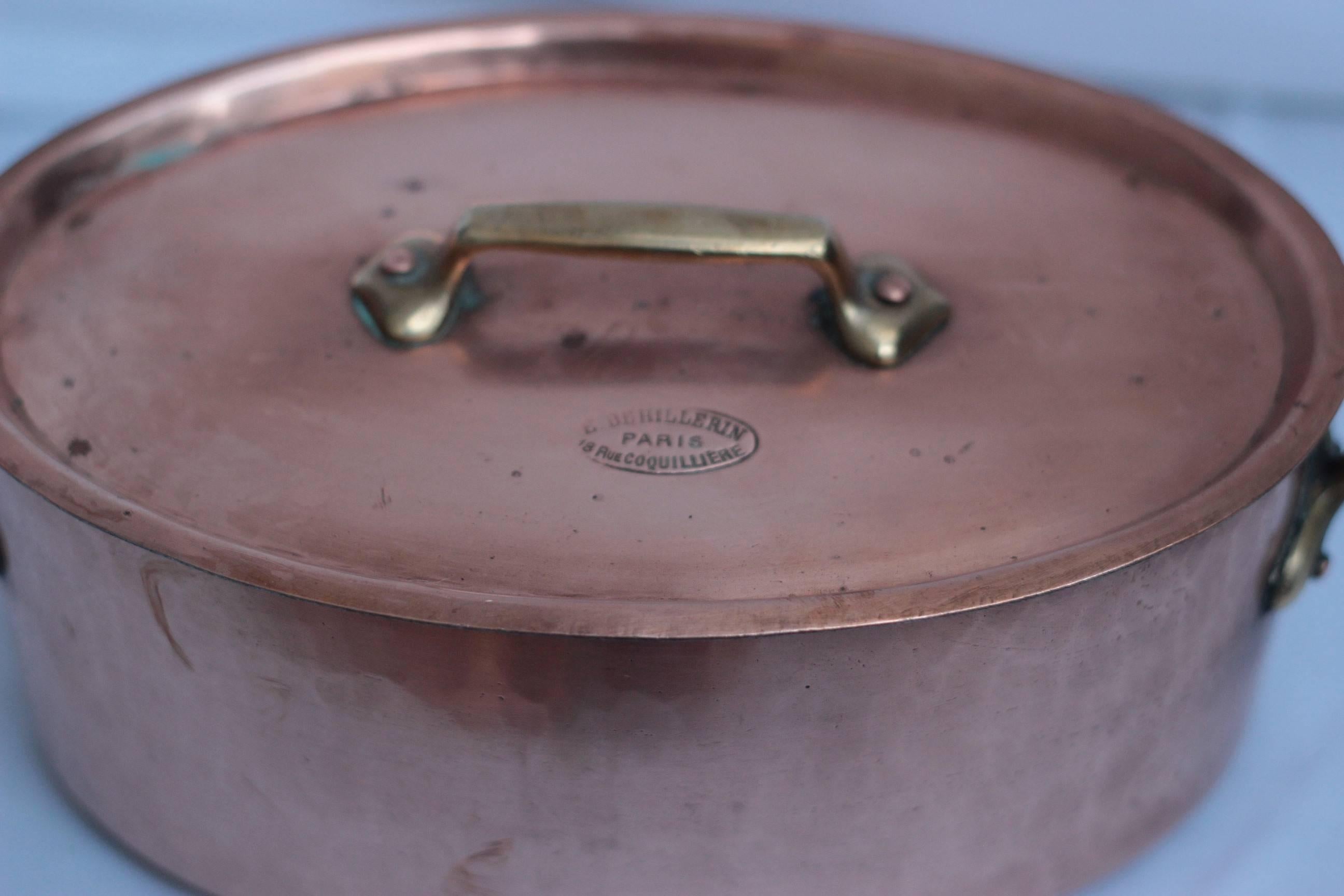 Set of 7 copper cooking pots stamped 