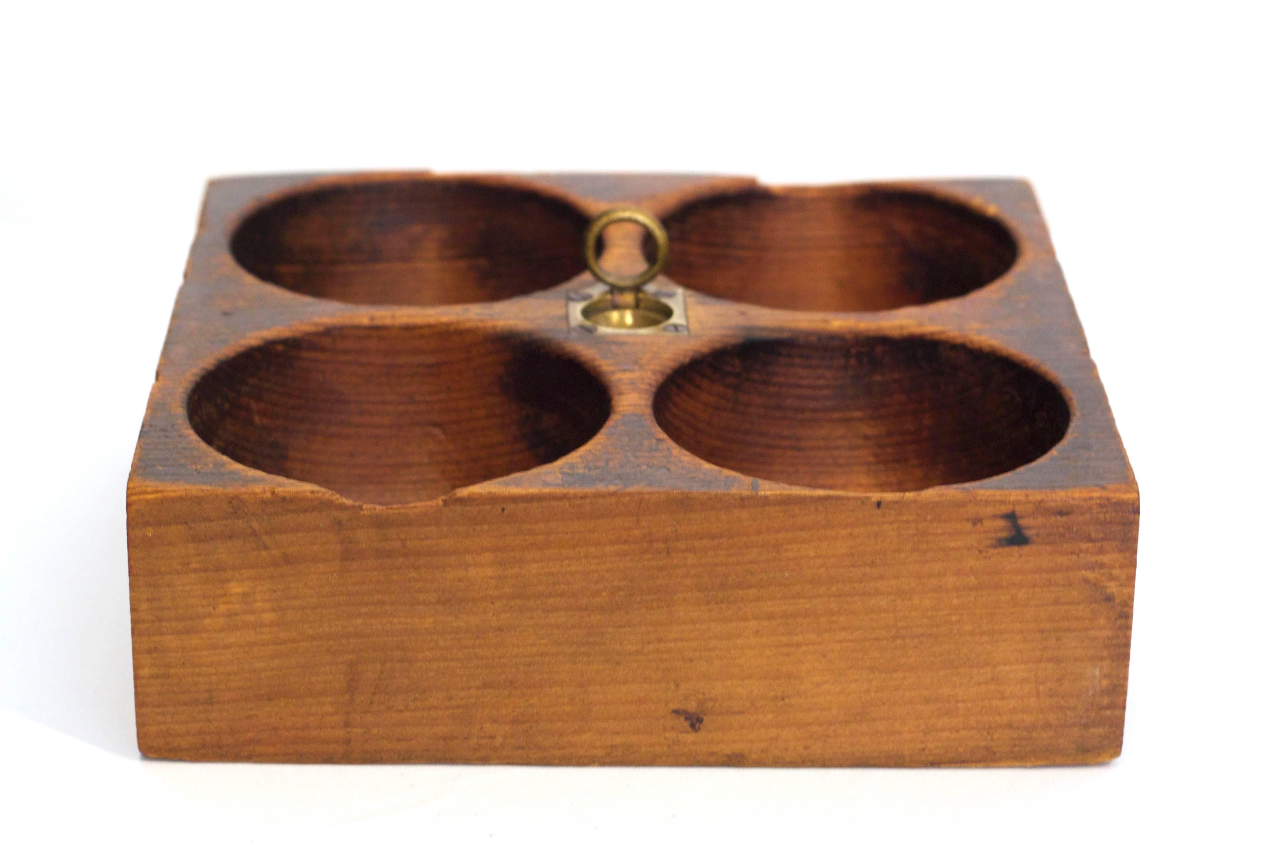 Wooden change caddy with 4 carved out change recepticals and pull up brass handle.