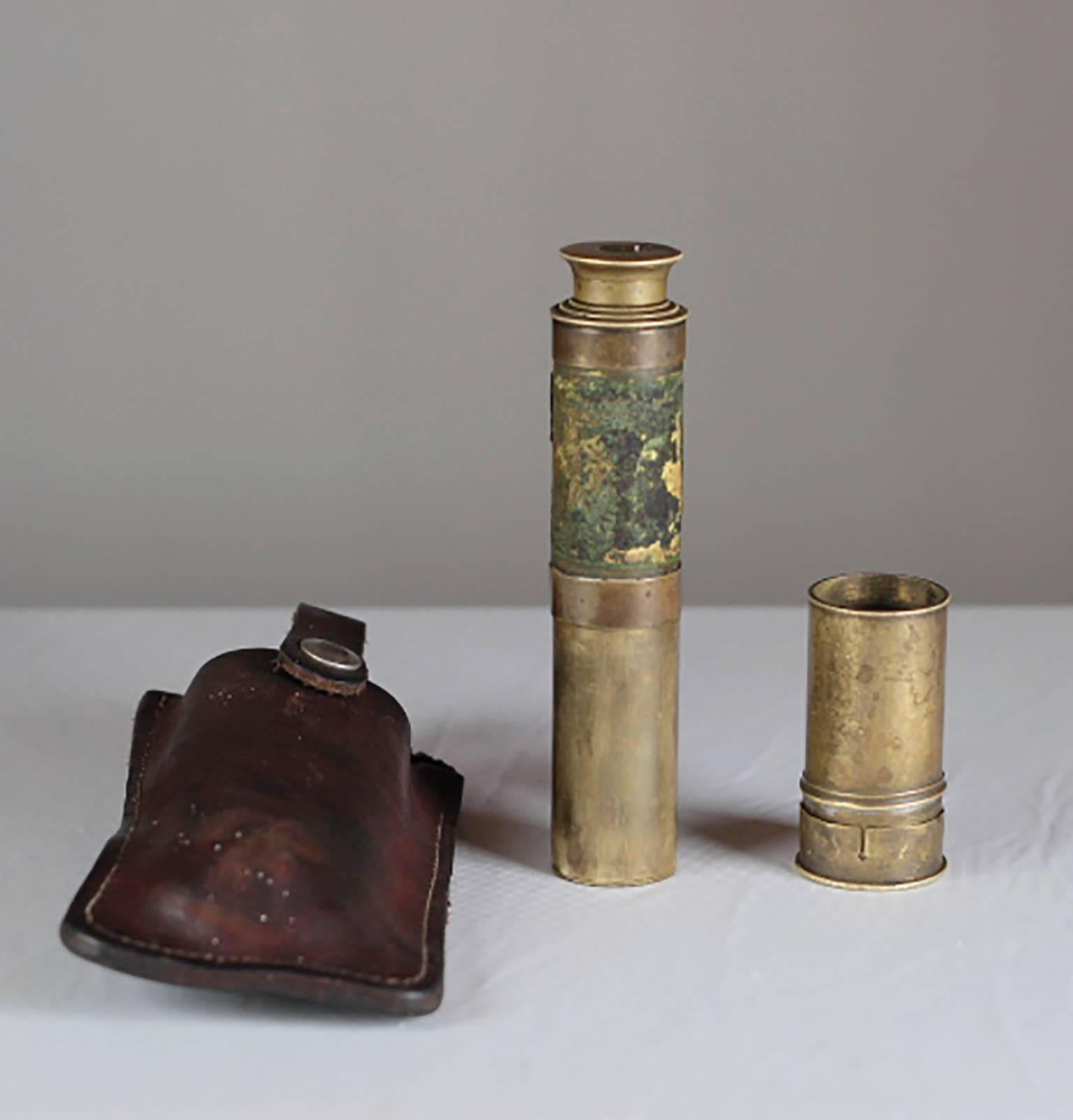 Telescoping brass spyglass with brass cover and leather case. 