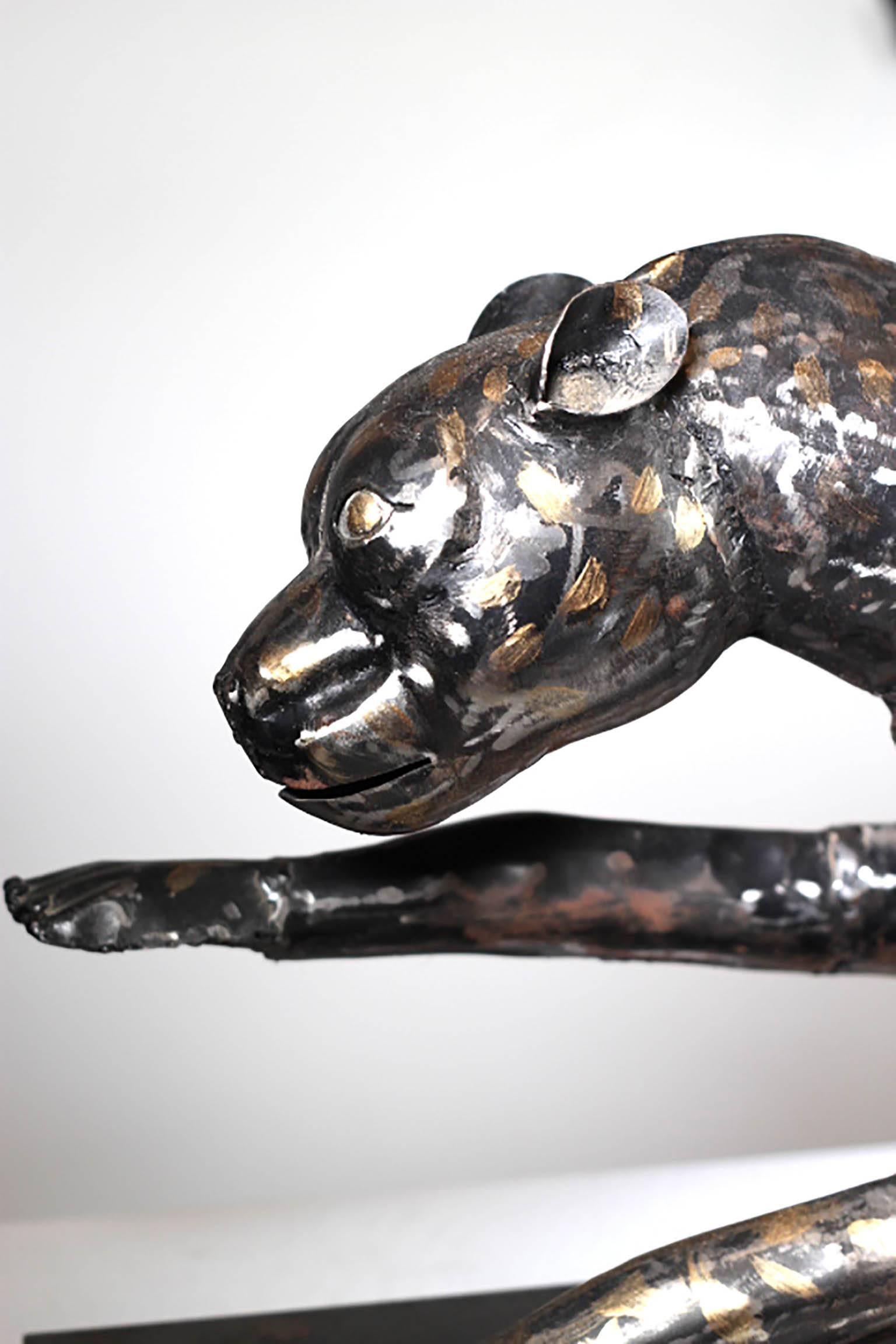 Brutalist metal running cheetah on metal stand painted black with gold spots and partly sanded, circa 1950s. Possibly steel.