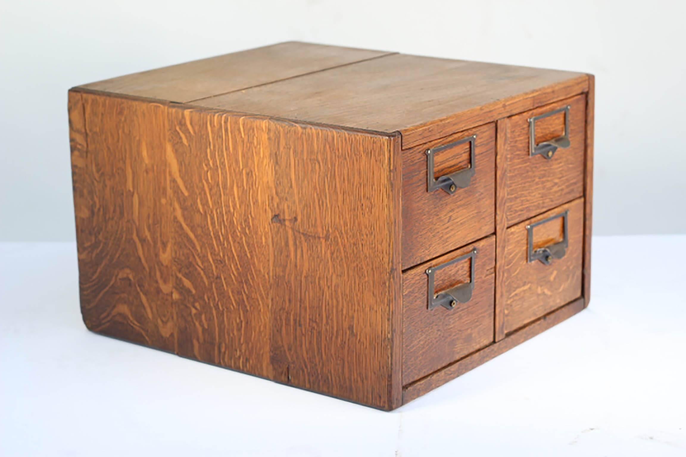Early 20th century four-drawer index card file cabinet with brass handles.