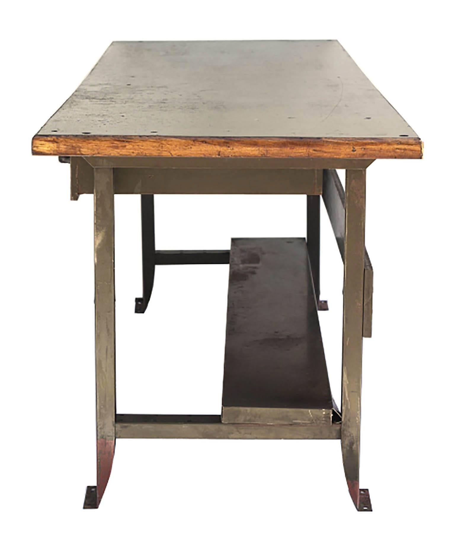 Industrial table on steel base with two original steel pullout drawers, original machine shop refinished wood top with oak banding. This table was made in San Francisco in the 1930s.