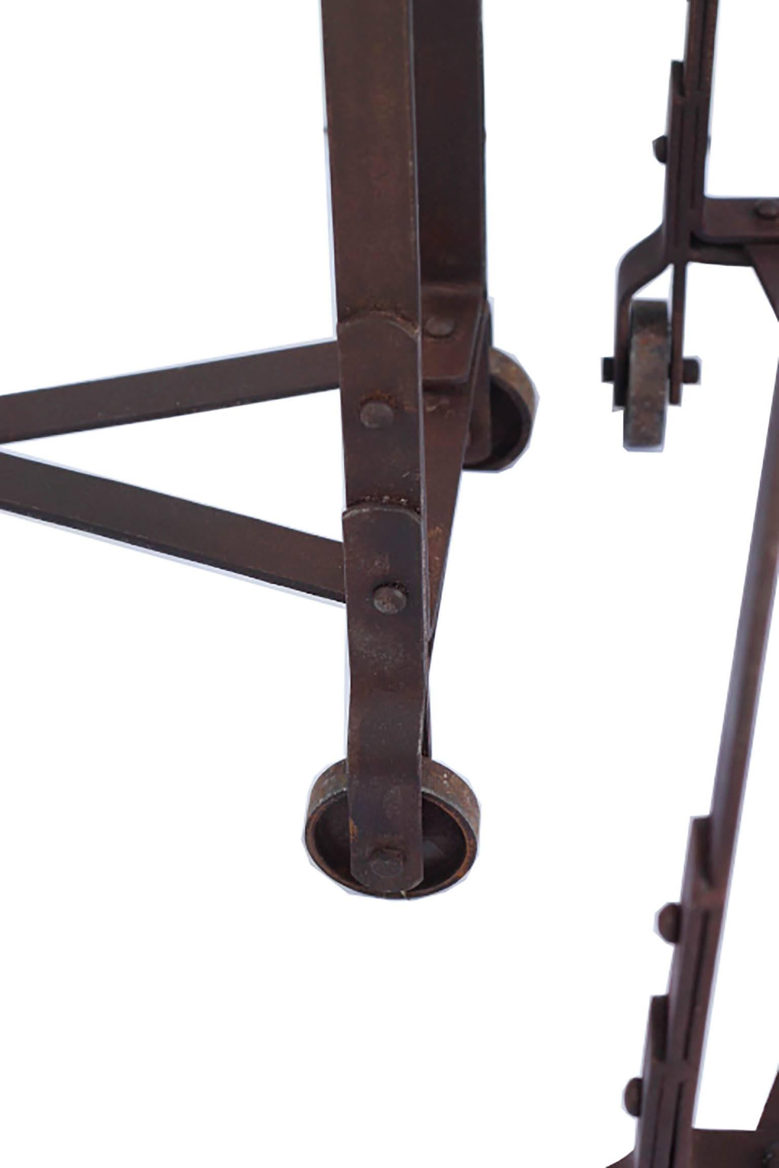 Pair of steel table bases with four steel wheels on each base and X-frame supports on the bottom. Suitable for the base for a console, dining table or desk.