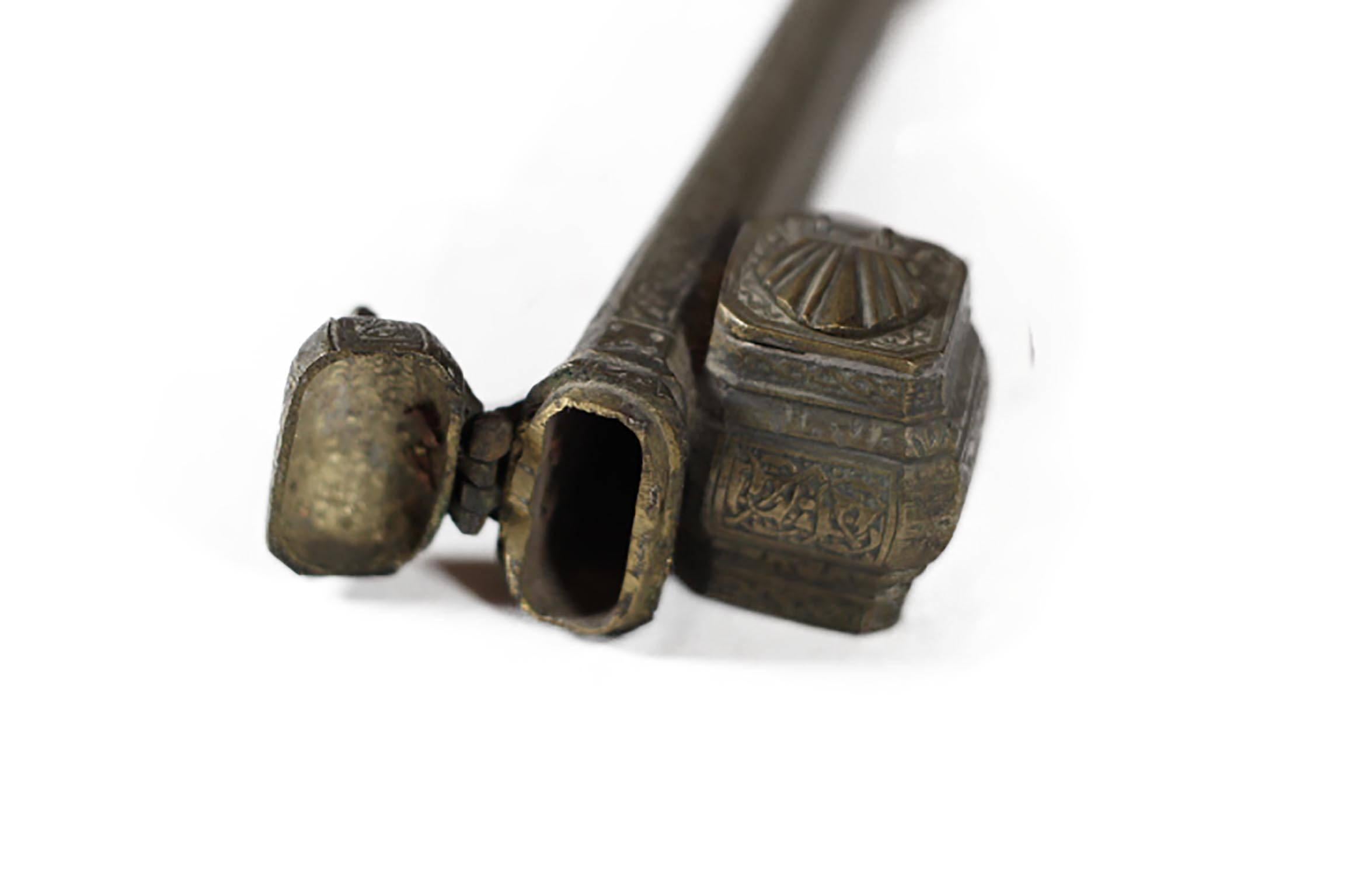 Highly decorated brass scribe box used to hold quills in the main chamber and ink in the side chamber. Both chambers have lids that open.8.5