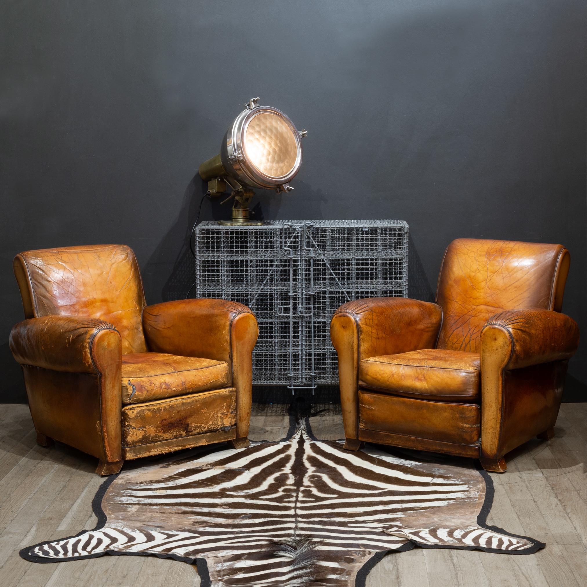 
ABOUT

Sold as a pair only.

Original sheep hide leather club chairs with burnished rivets trimming the back. Carved wooden feet and rolled arms. 

    CREATOR Unknown. Possibly made in France. 
    DATE OF MANUFACTURE c.1930-1940.
    MATERIALS
