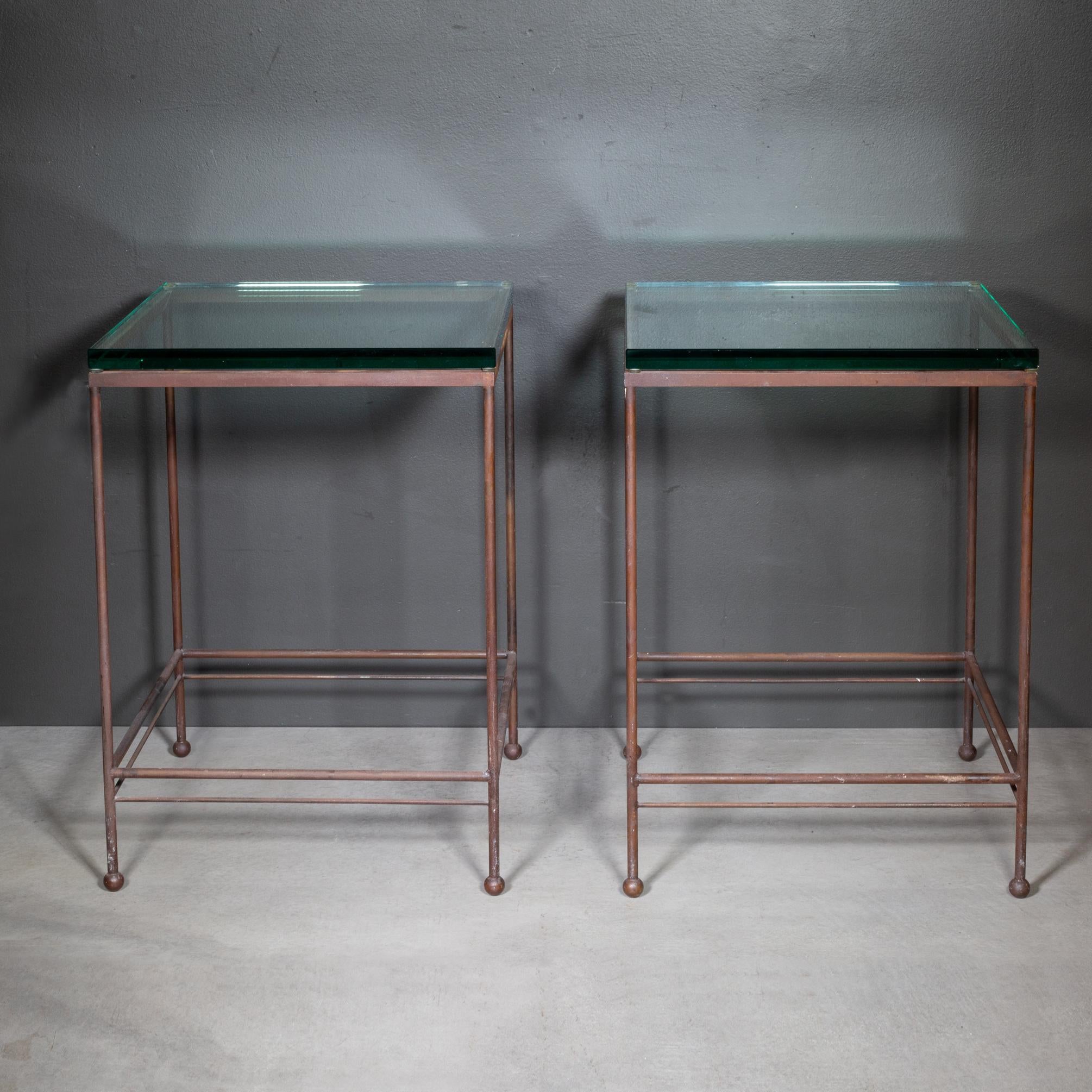 ABOUT

A pair of steel end tables with thick glass shelves, ball feet and double bar bases. 

    CREATOR Unknown. 
    DATE OF MANUFACTURE Late 20th c. 
    MATERIALS AND TECHNIQUES Steel, Glass.
    CONDITION Good. Minor wear consistent with age