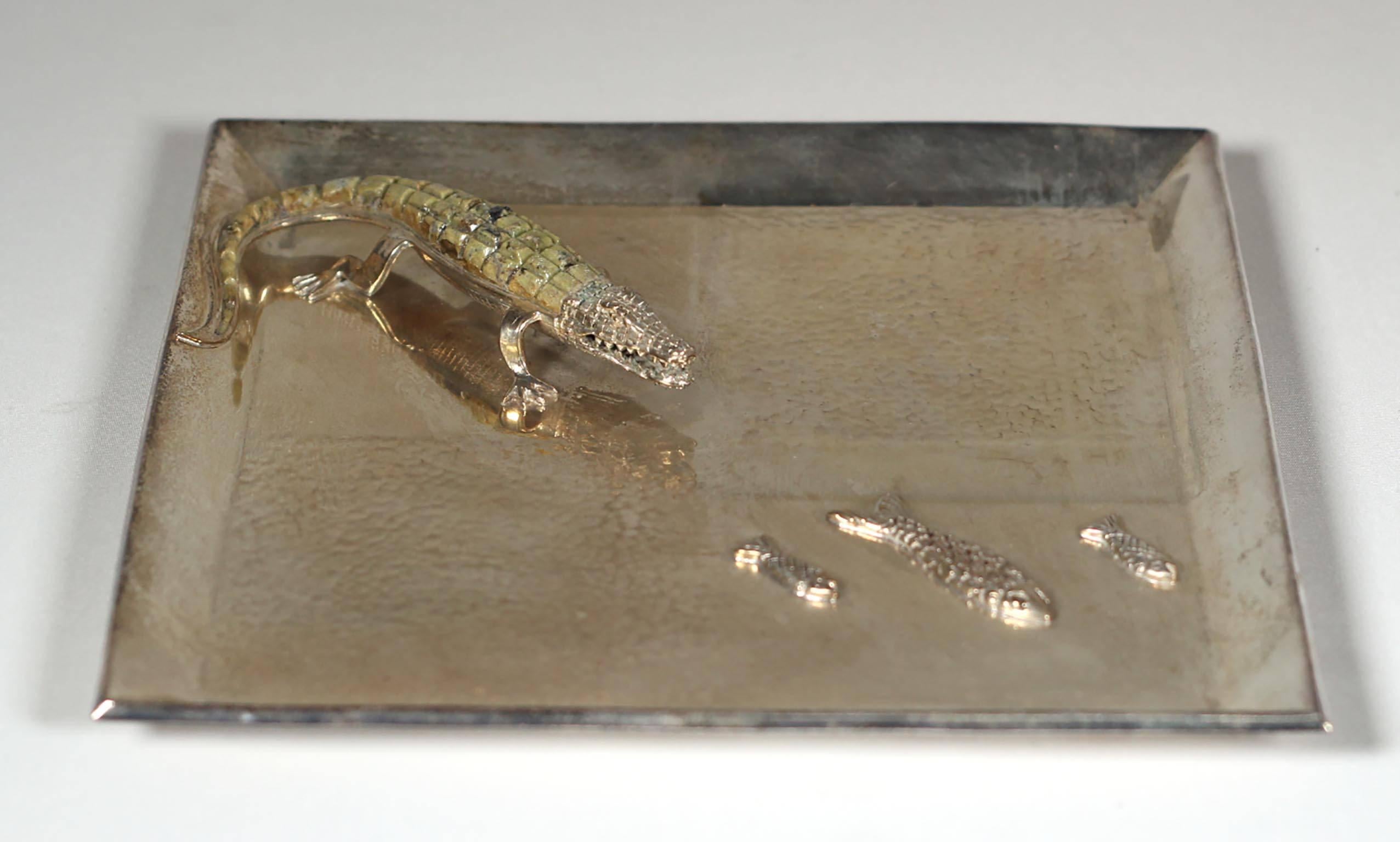 Charming silver plated tray featuring an alligator pursuing three fish. The alligator's back and tail are covered with a lovely verdigris green stone possibly Malachite.