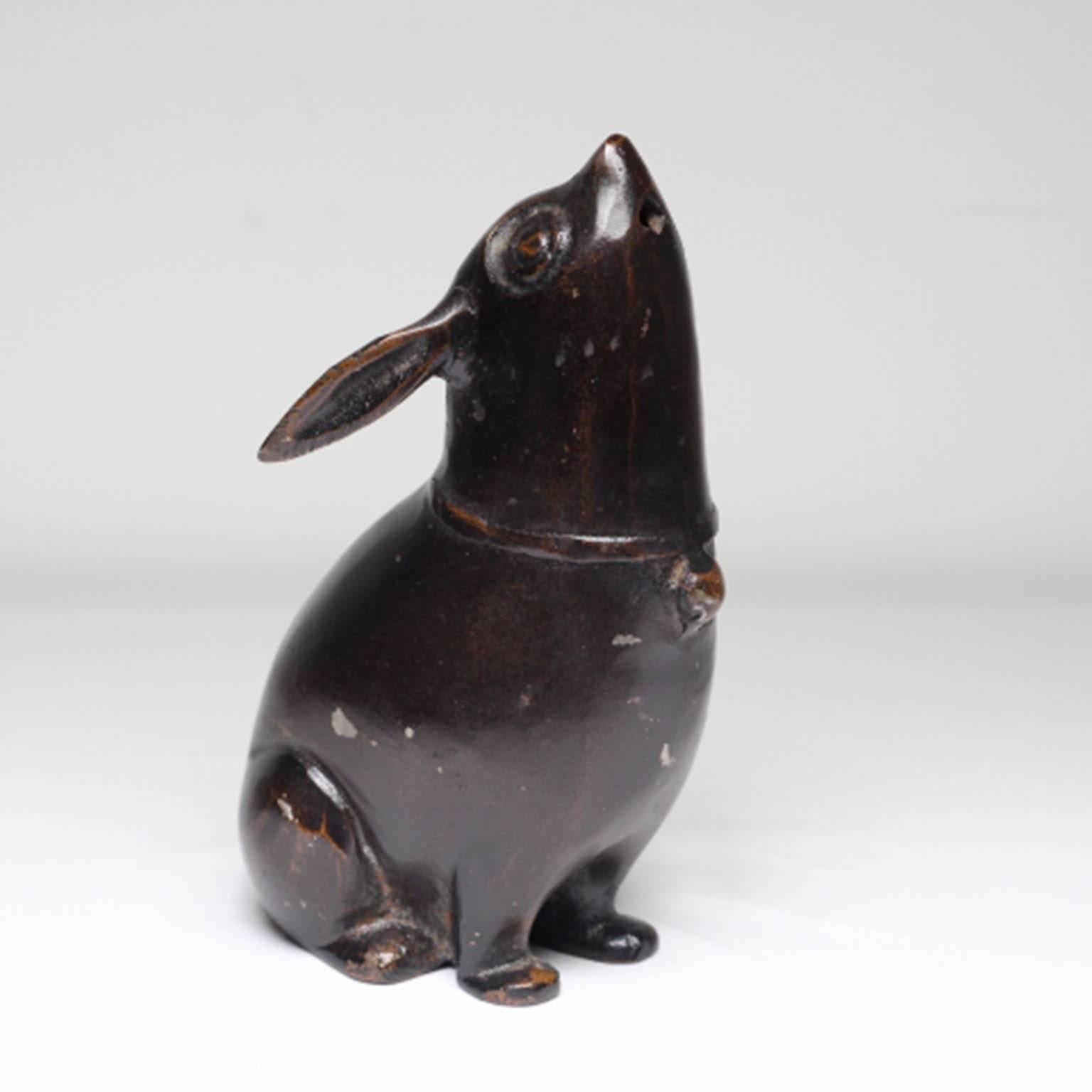 Charming bronze Japanese rabbit incense burner, circa 1940-1960. The incense is held in the mouth of the rabbit while it burns.