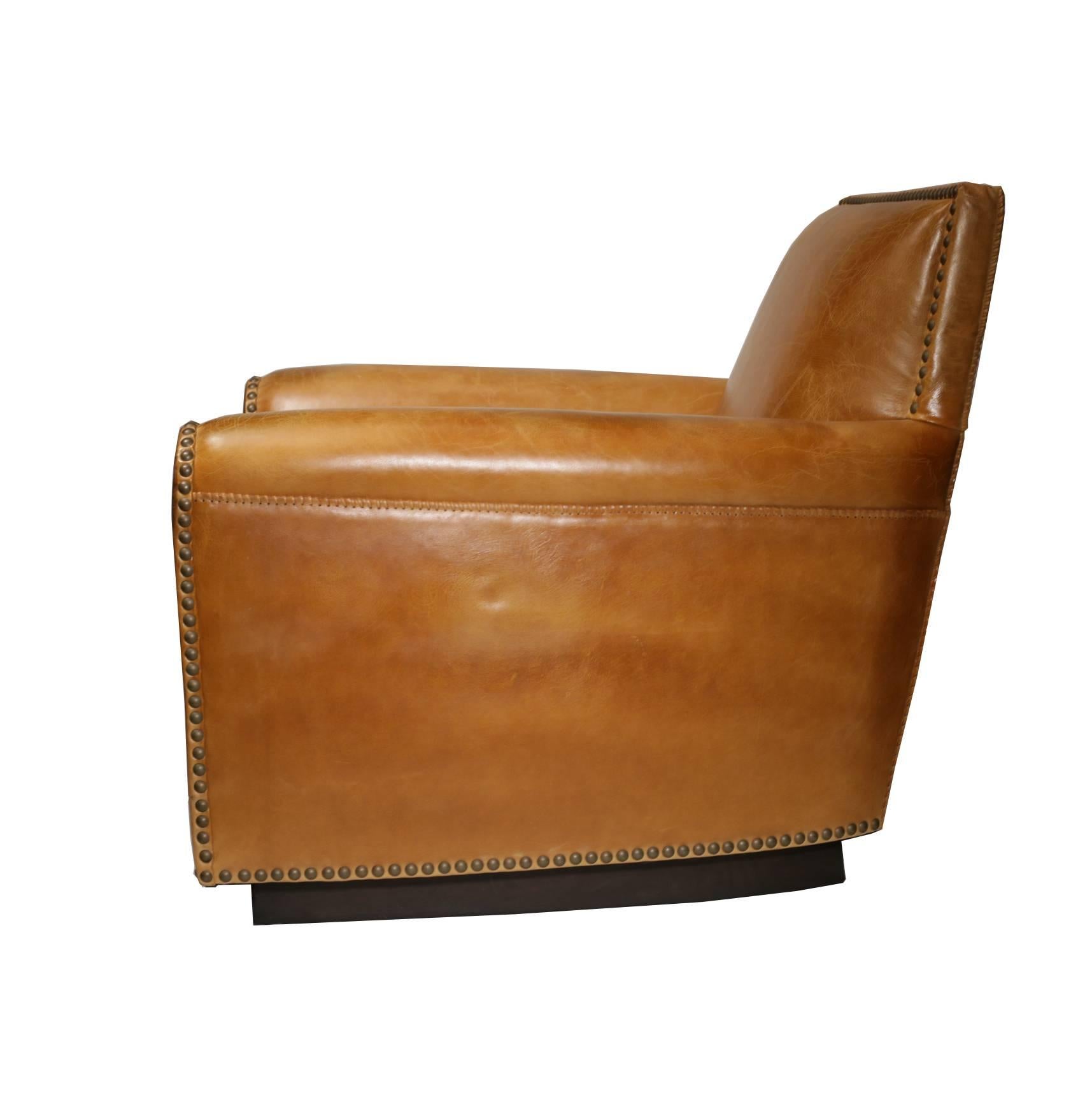 This chair was purchased new and has never been used. 

The Mid-Century lines of a 1940s lounge chair take on a Western spirit in distressed leather with whipstitched edges and bold hammered nickel nailheads.

Chair as shown:
Luxury down seat