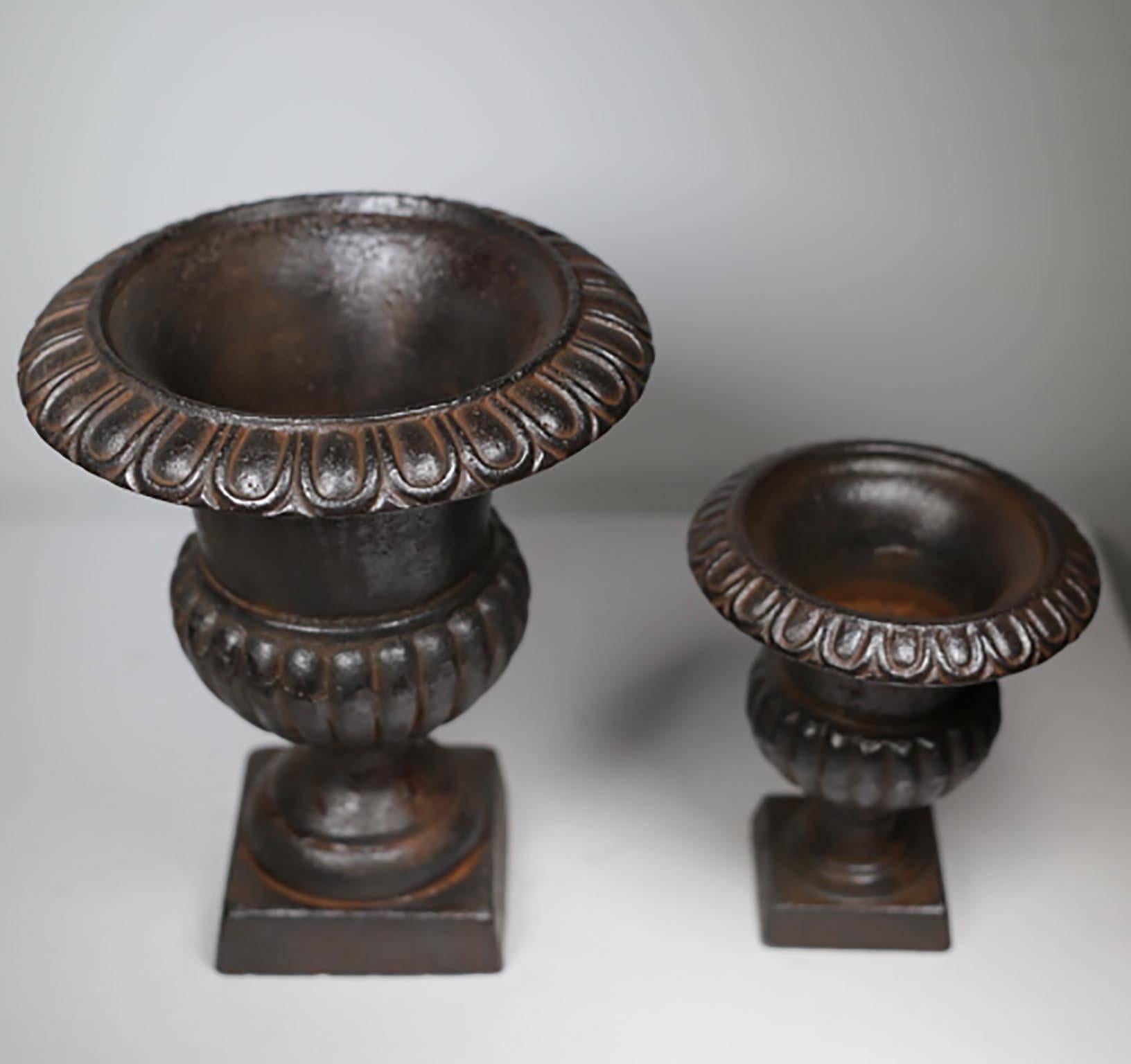 On cast iron urn, circa 1930s. The small one has sold. The large urn is still avaiable. 