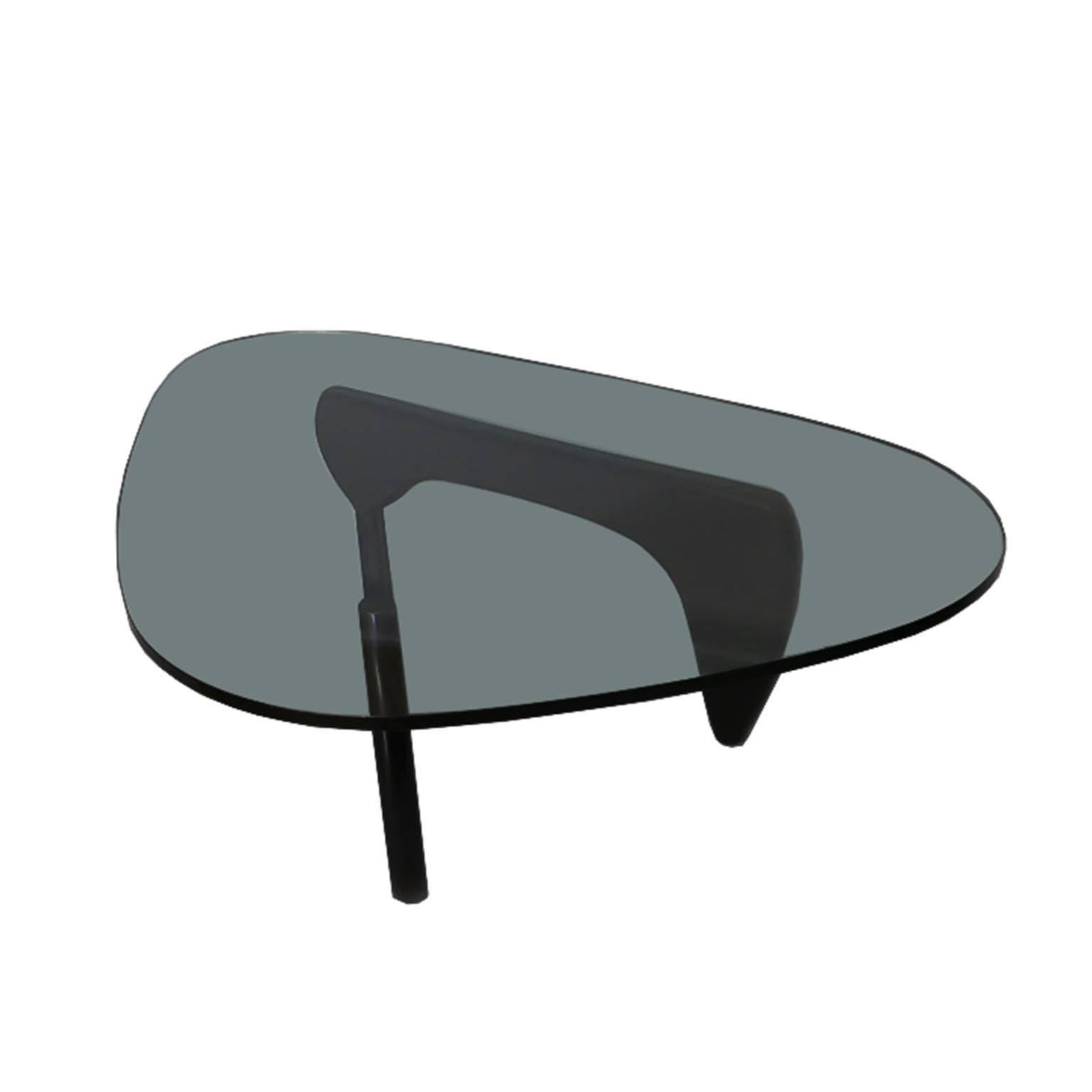 Noguchi coffee table designed by Isamu Noguchi for Herman Miller. Not a reproduction. 
Solid wood base in Noguchi black, 0.75" thick glass with Noguchi signature.