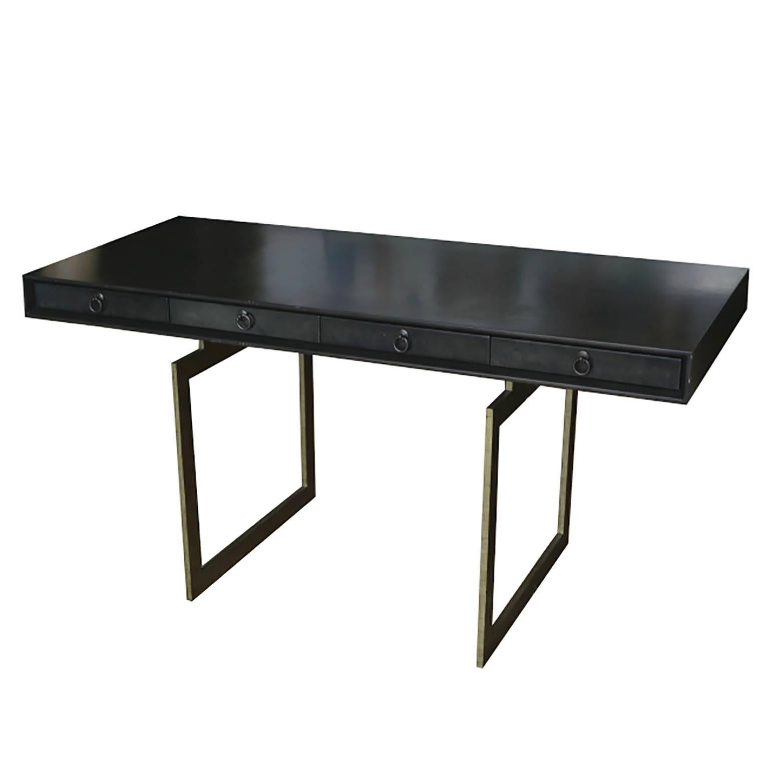 A stylish desk that appears elegant and simple, but offers enough surface space for serious work. The desk is wrapped in black vellum cow hide with Hickory lined drawers and brass pulls framed by a beveled detail. The only ornamentation of an