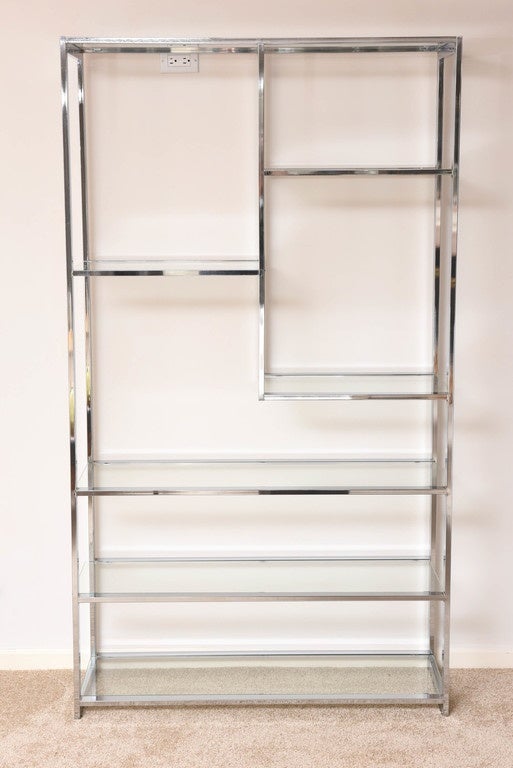 This polished chrome and glass étagère is attributed to the iconic furniture designer Milo Baughman and it dates from the 1970s. Baughman designed collections for Thayer Coggin furniture company.

For best net trade price or additional questions