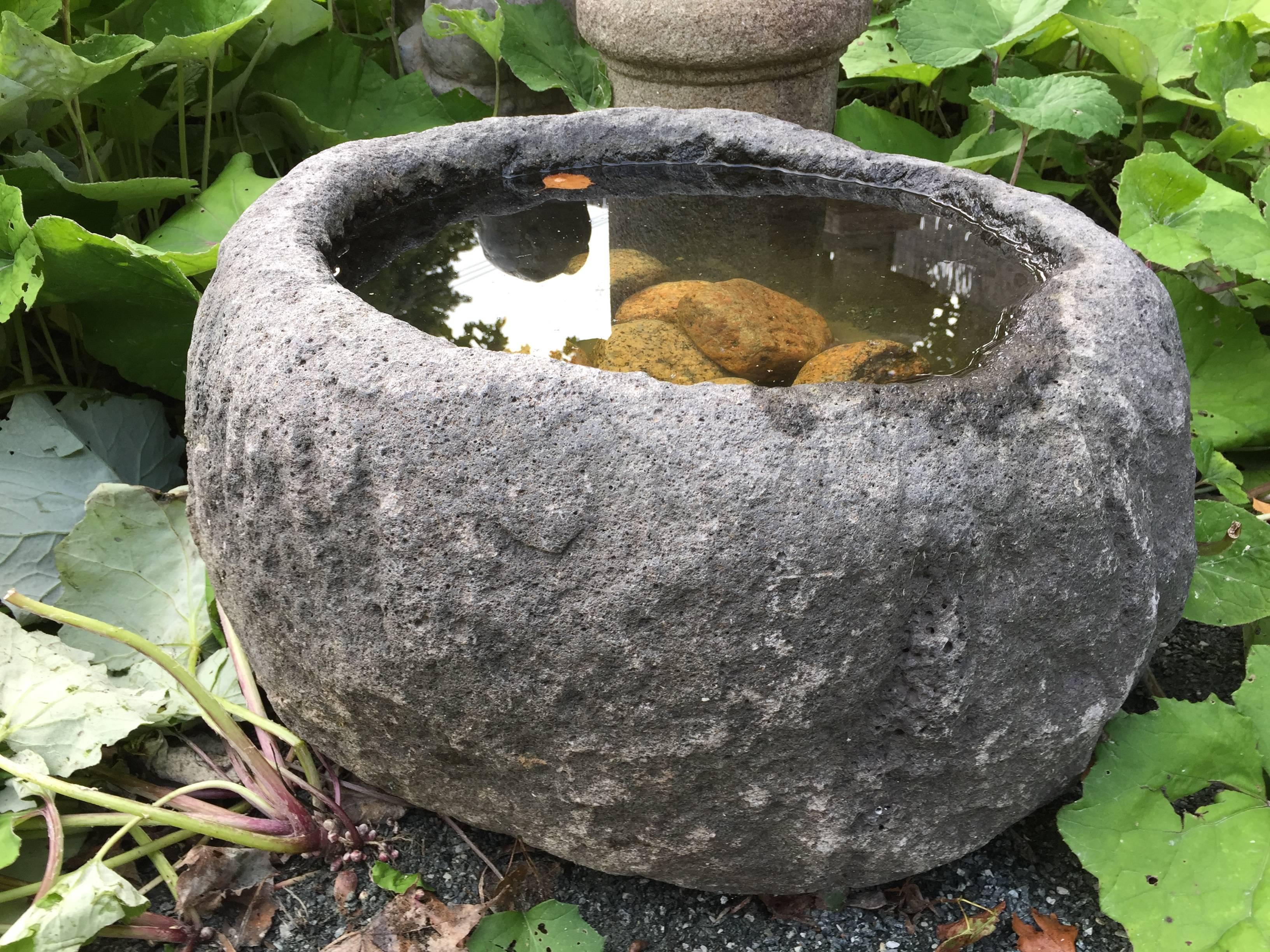 A fine old Antique Japanese  medium sized old pumpkin shaped solid planter or water basin, hand-carved from solid stone, 19th century.

Dimensions: 12 inches in height and 20 inches in width and 20 inches deep

Stone water basins are singularly the