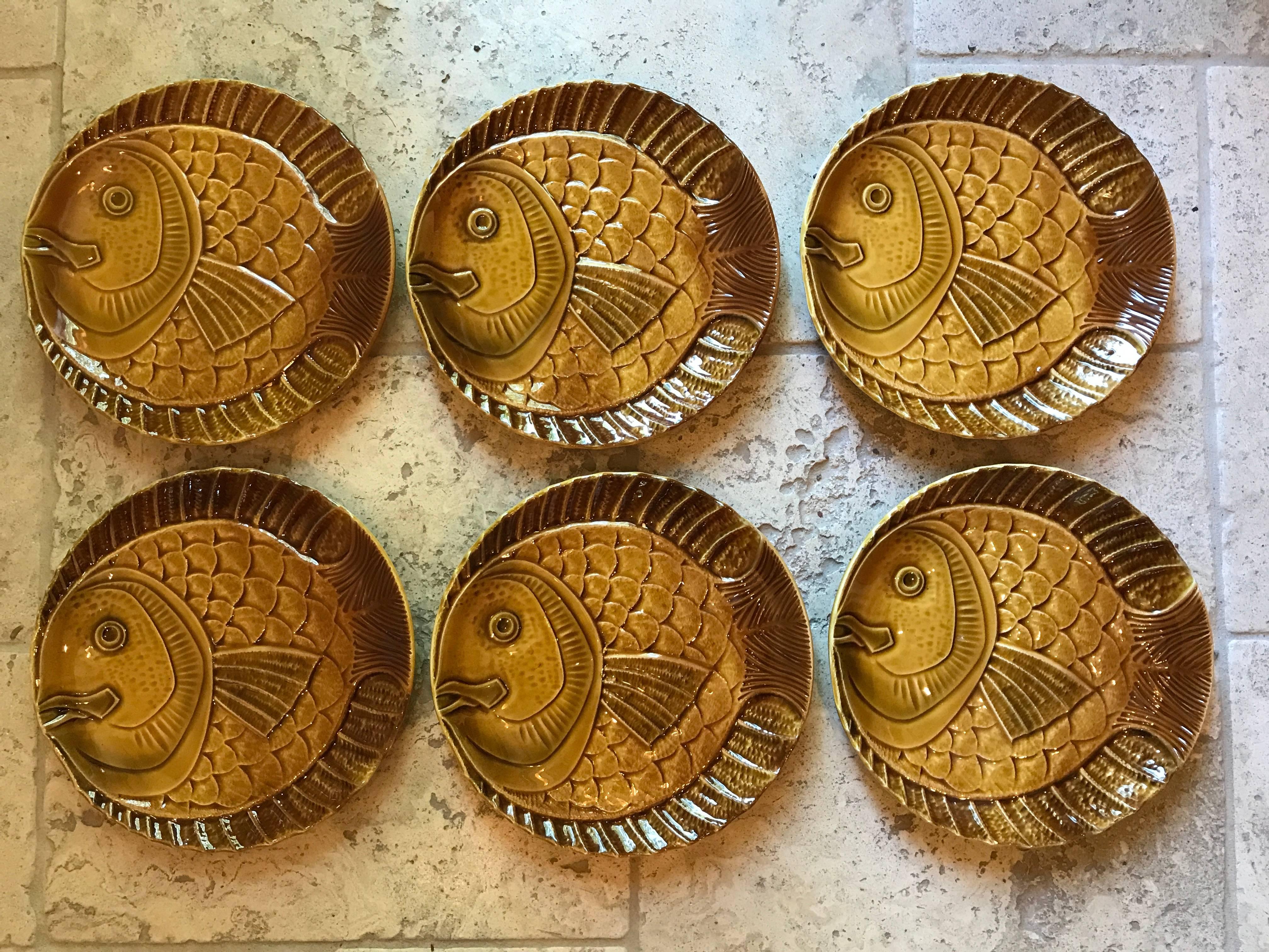 This wonderful and scarce set of original handcrafted, hand glazed fish plates from Sarreguemines, France are impressive in design, quality, and sure to garner favourable dinner time conversation. Lovely to touch.

Set of five (5) + we will