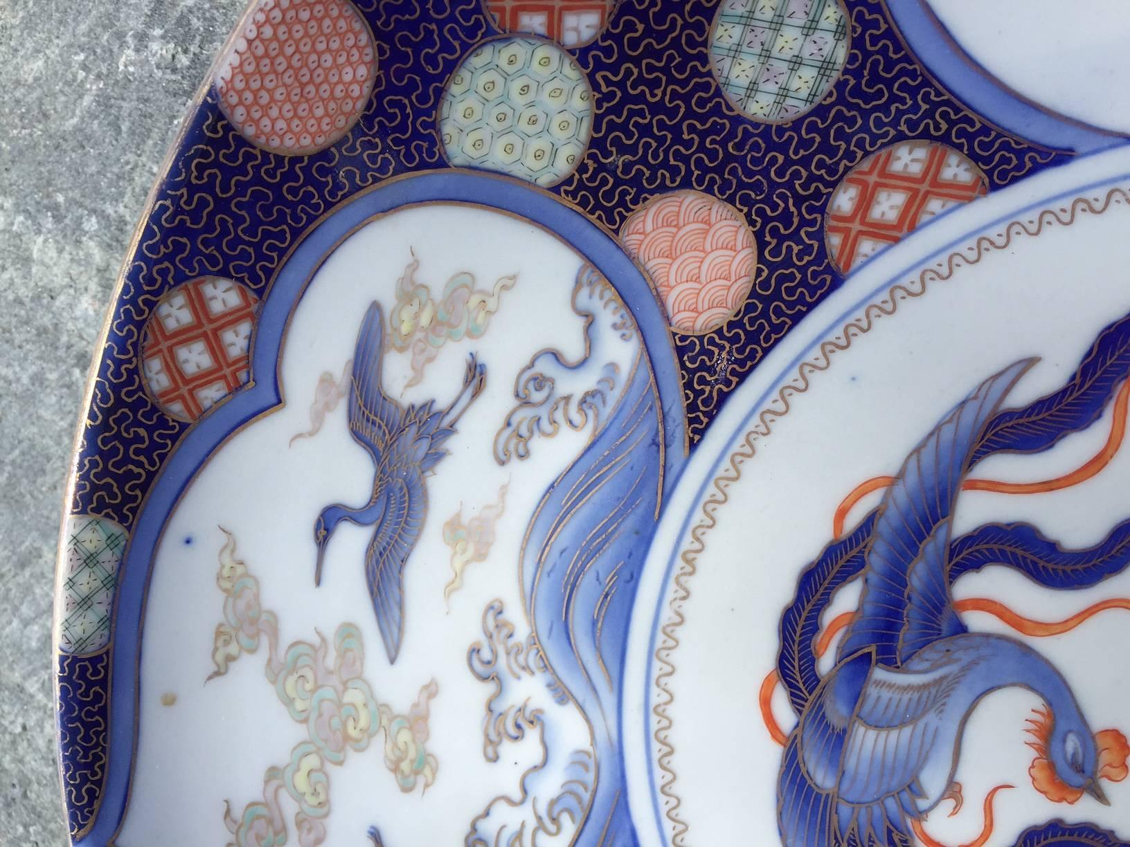 Japan, an antique hand-painted porcelain chargers ozara.

From famous designer Fukagawa, Imari, Fukagawa mark reverse, fine quality late 19 century, cobalt blue under glaze, gold gilt, iron red, gray “Iris, koi, herons with bird of paradise”