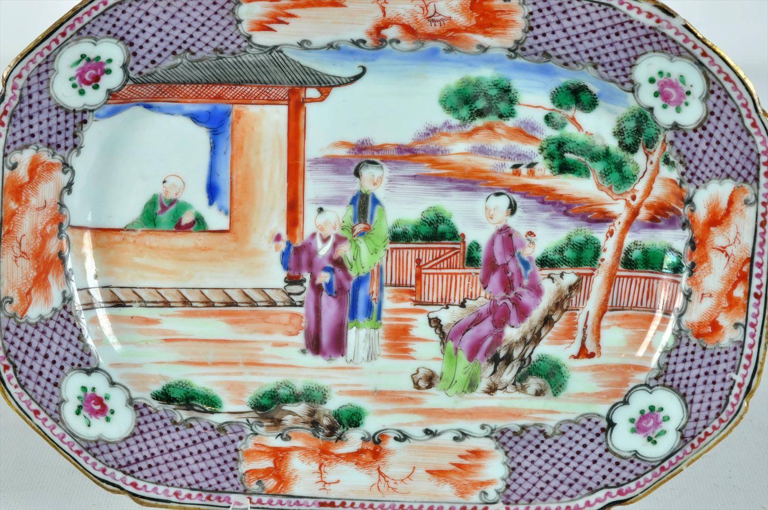 A lovely and scarce China Export Rockefeller pattern hand-painted porcelain serving dish in the Mandarin palette, with red scale, plumb, and gold gilt bands/edges depicting scenic cartouches of women and children in pavilions and gardens, late 18th
