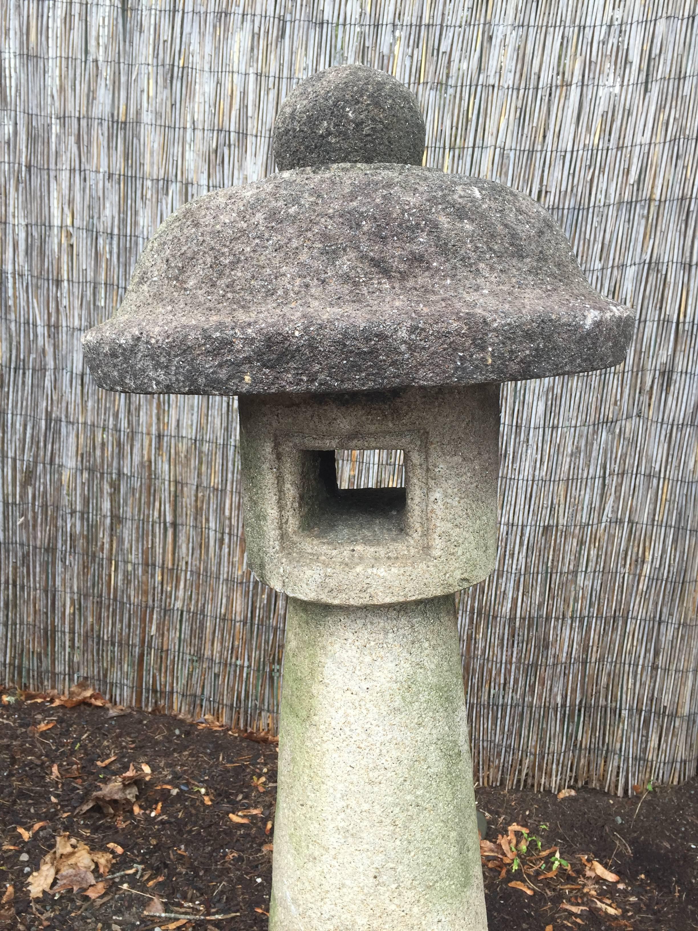 Japan, a tall elegant and scarce hand carved stone lantern dating to the 1920s. This 36 inch high by 20 inch diameter lantern is wonderful in its design simplicity and would be appropriate for any Mid-Century Modern, arts and crafts or traditional