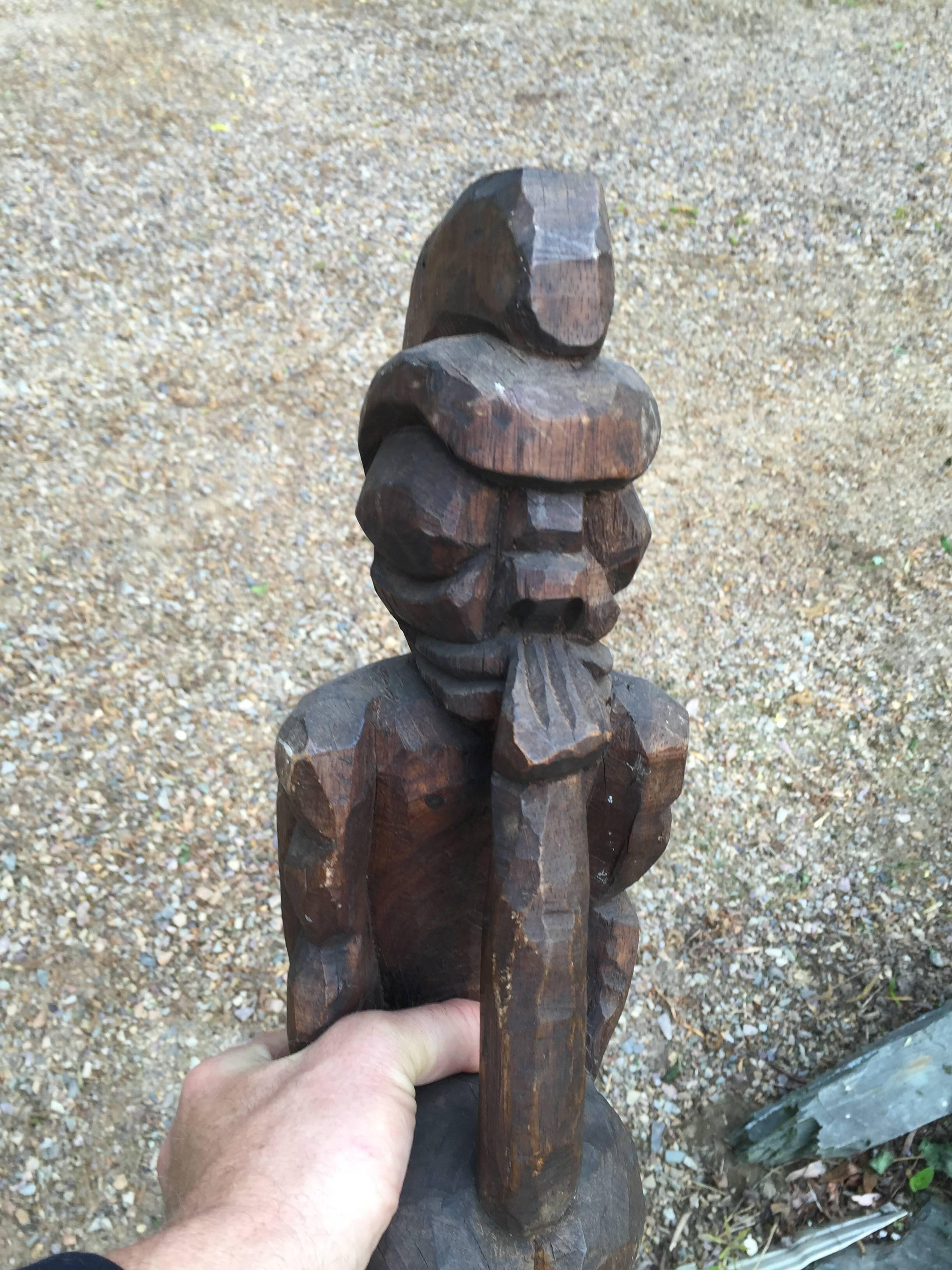 A monumental and rare Hawaiian hand-carved Koa wood Tiki sculpture featuring a Hawaii Ali'i Chief with traditional helmet, circa 1900. Fine old dark patina from appropriate great age. We have not seen another.

Provenance:  This comes from an