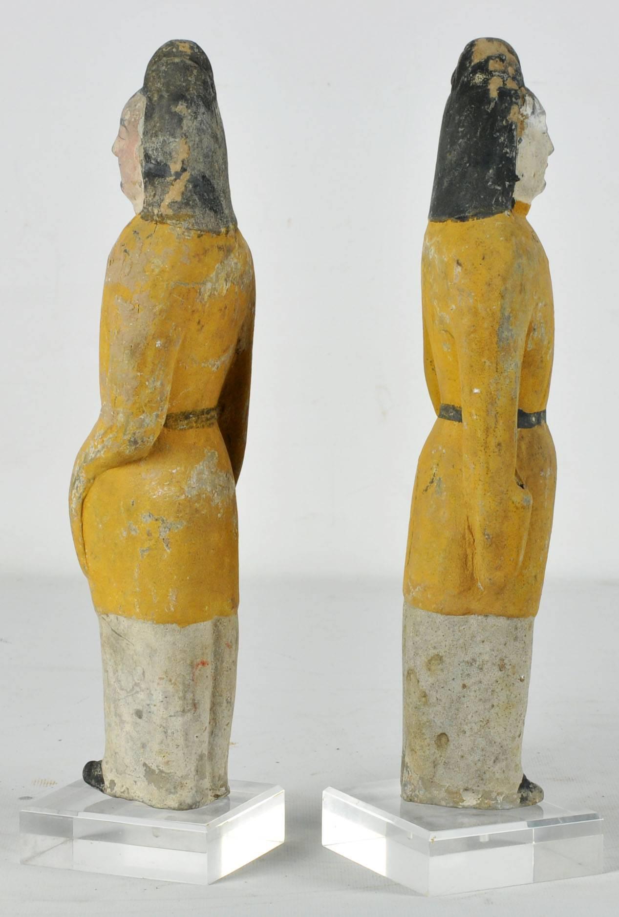 This is a lovely pair of 1400 year old figures from ancient China, a beautifully hand painted pottery pair of military officers wearing tricorn hats and belted tunics, 12.5