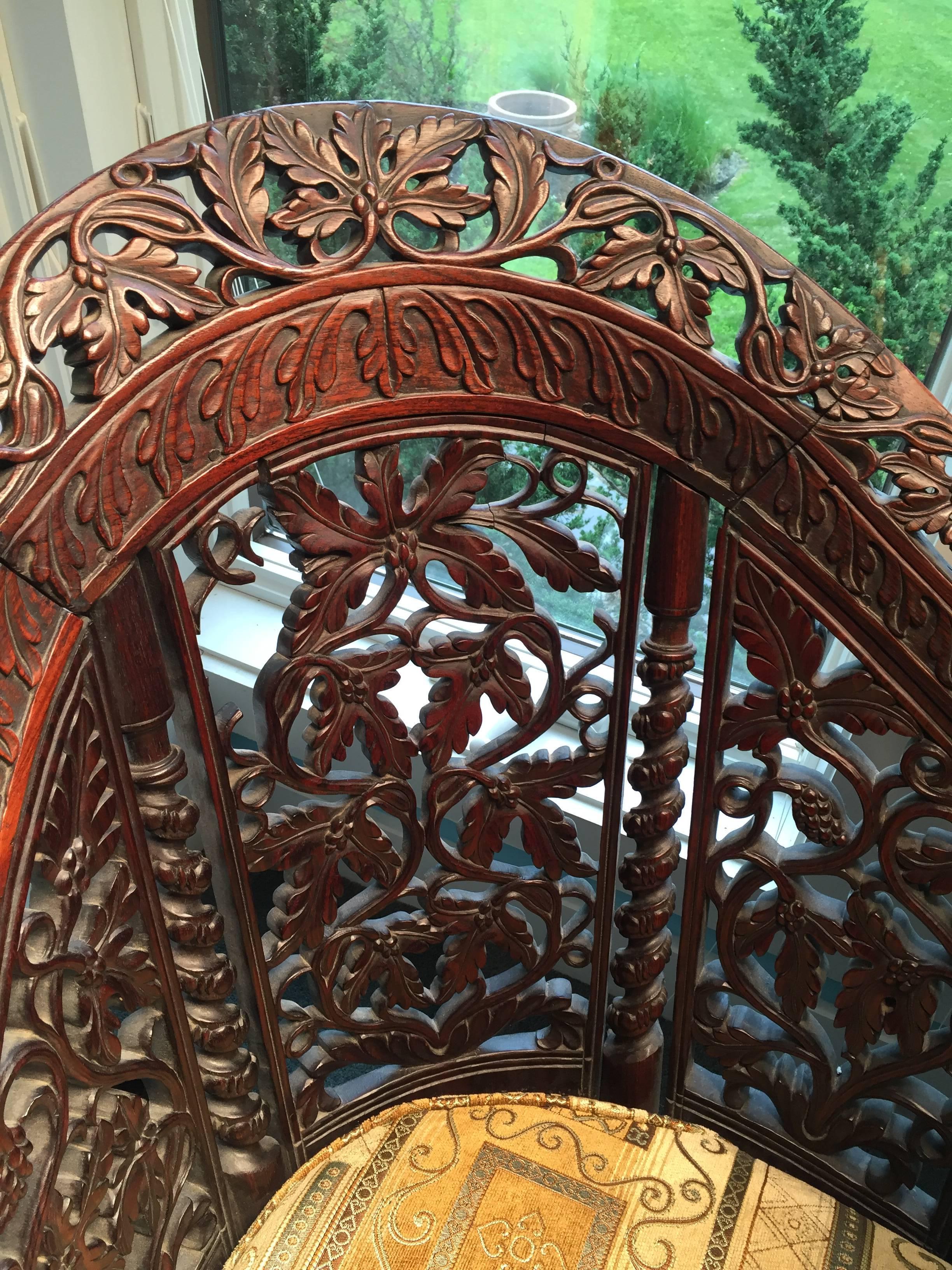 A highly decorative and hard to find Anglo-Indian finely carved and pierced rosewood or teak wood double high back settee with prolific flowers and grape design and with new seat and covering.

Period: circa 1860-1880, likely carved from the Bombay,