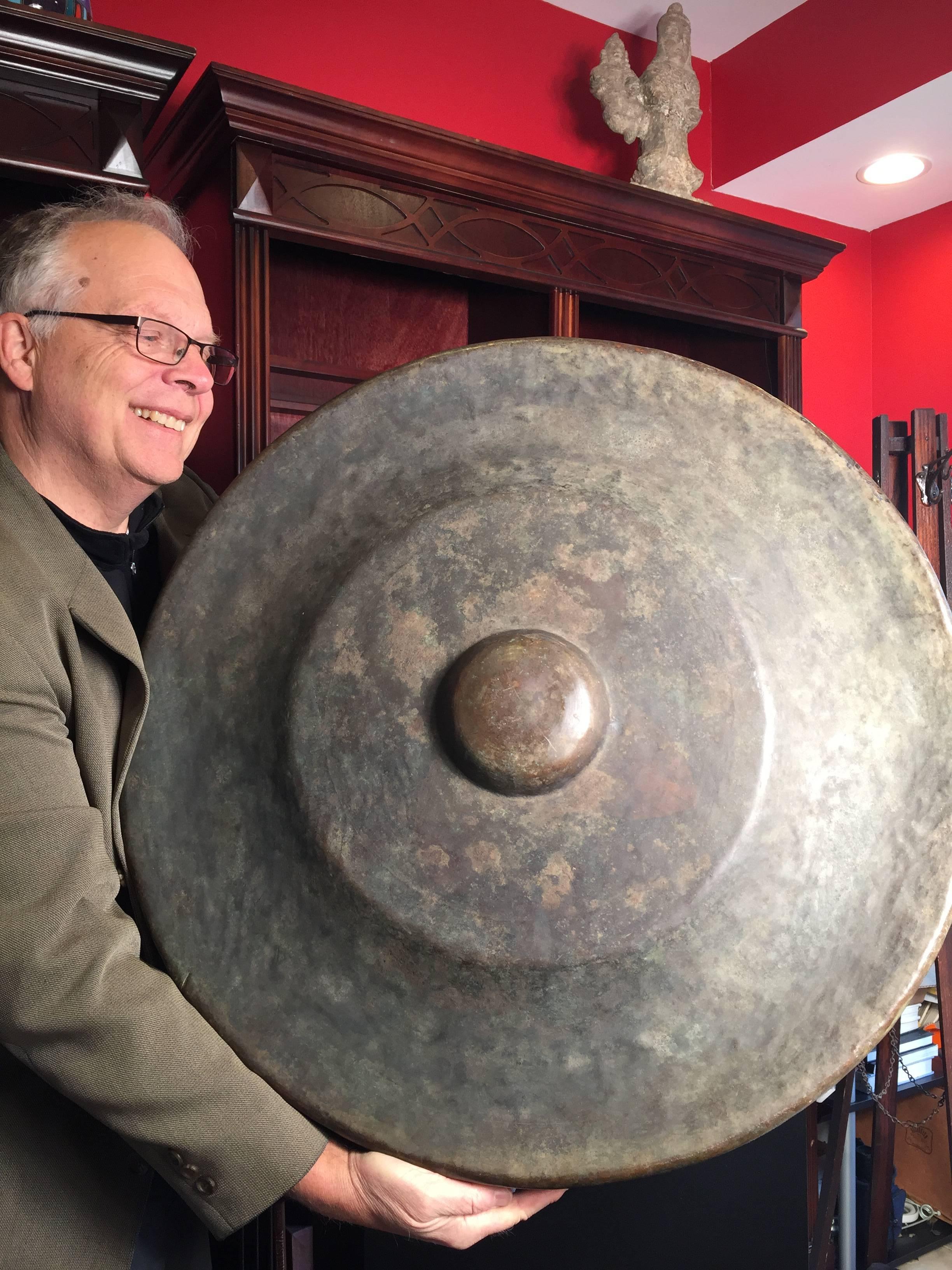 Here's a very nice large-scale 19th century bronze garden temple gong with striker which we just found in an old Kyoto collection.

Dimensions: substantial  29 inches diameter and comes complete with an old striker.

Hand made and hand cast antique