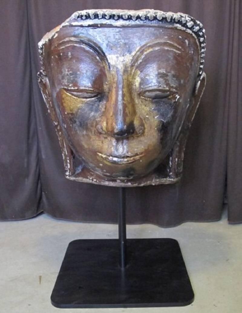 For your collecting pleasure please consider this fine and powerful Myanmar Burmese monumentally carved Antique Buddha head in the “Ava” style.

Dimensions: The large Buddha head itself measures 24 inches high and with its custom iron Stand 35