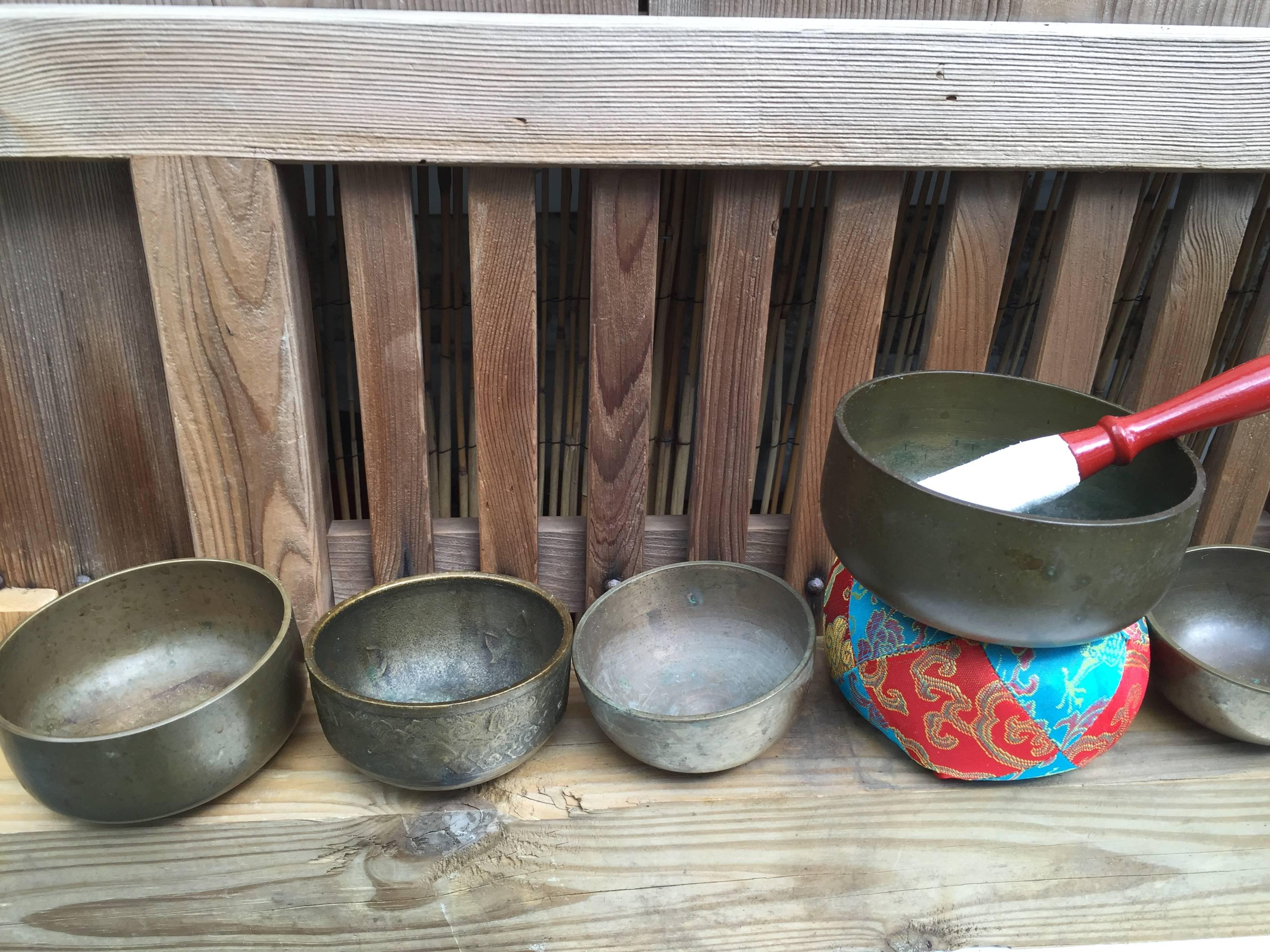 From Japan, a very nice collection of eight (8)  graduated small to medium scale mid-20th century bronze temple meditation bells with handmade cushion and hardwood striker set.

Our bells yield  serene resonating sounds guaranteed to please