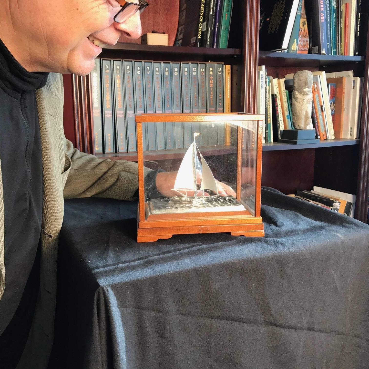 Mint, Signed and Boxed

Japan, a fine sterling silver model of a yachting vessel sailing on a sculptured sterling silver base of high seas waves

It is accompanied by a fine original wooden collector box, mid-20th century. 

Dimensions: 7.5 inches