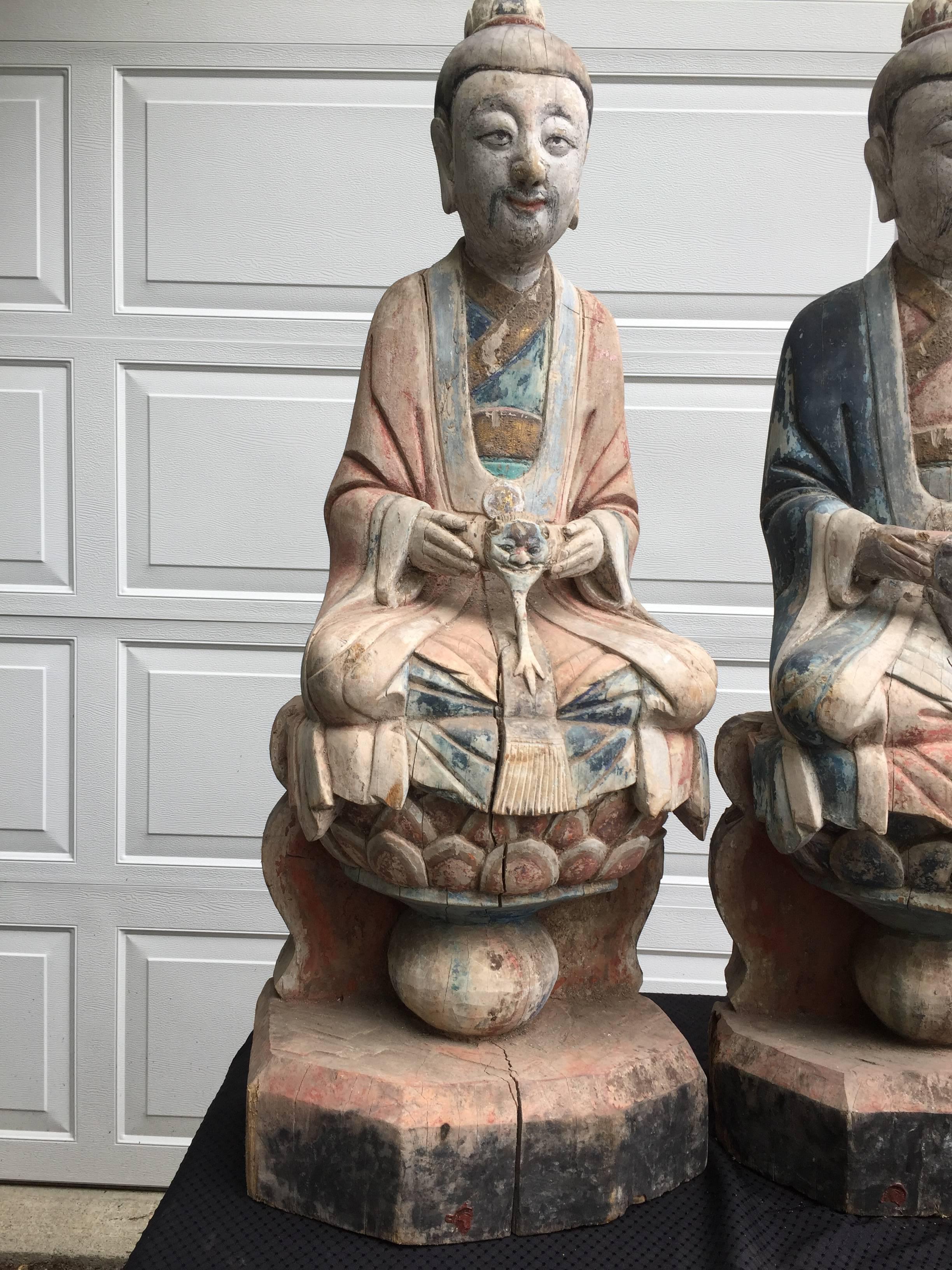 China, a  hand carved and hand painted wood group of three (3)  Taoist Trinity figures: The Three Pure Ones.

Measurements: 36 inches high and 14 inches wide and 10 inches deep each,

Age:  mid-late Qing dynasty, 18th-19th century.

Background: