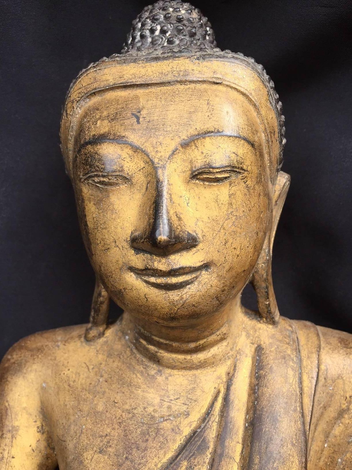 Myanmar, Burma, Mandalay, a fine gilt bronze seated Buddha dating to the 19th century. The effigy of the Buddha with realistic and joyful face cast I solid bronze and gilded with modest wear from appropriate age. A good consideration for your