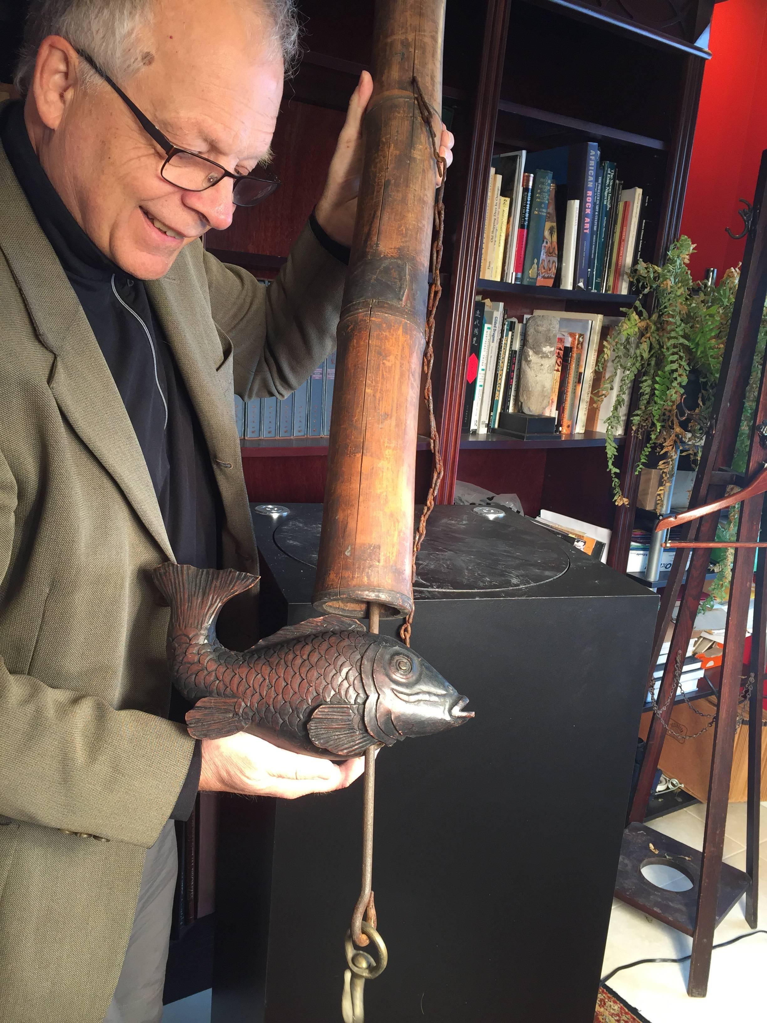 A fine old Japanese kettle hook with bamboo post, iron hardware and hand-carved hardwood koi prosperity fish crossbar.

Hand made, hand carved, and hand forged  Hard to find complete and in tact as is this example 

Originally used in Japanese main